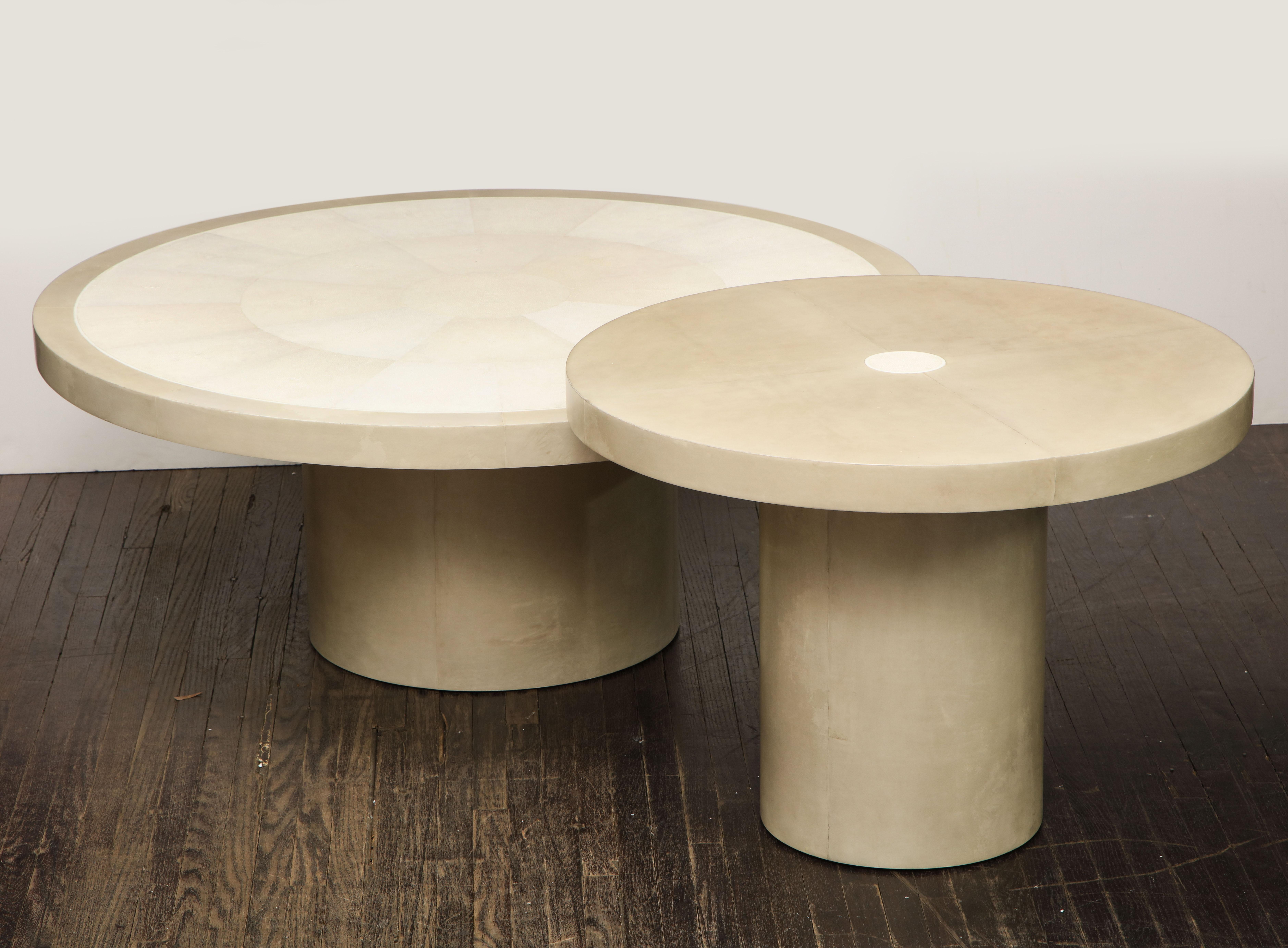 Set of 2 custom round genuine shagreen and parchment table with bone trim. The larger table measures 42