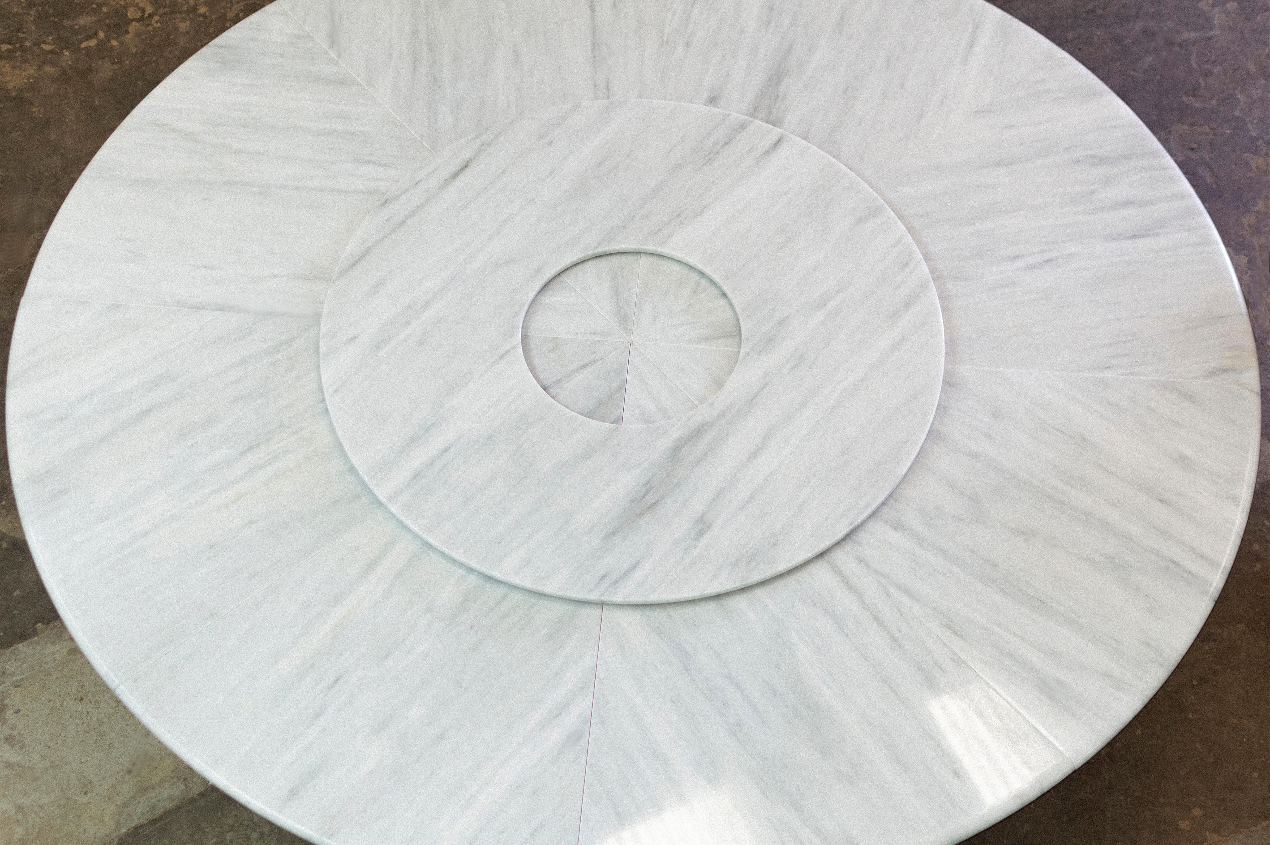 The Aragon dining table features a wrapped bronze base with a White Ibiza Marble top with rotating server (formerly known as a Lazy Susan) supported by an elegant gently curving wood support. 

Measurements are 108