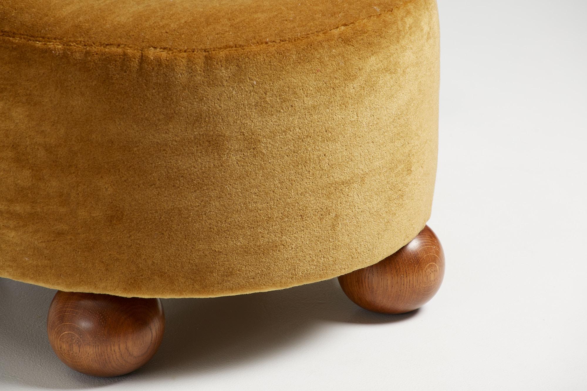 Dagmar Design - Round Ottoman

Custom-made ottoman developed & produced at our workshops in London using the highest quality materials. These examples are upholstered in a mustard mohair velvet by Pierre Frey with fumed oak ball feet. This ottoman