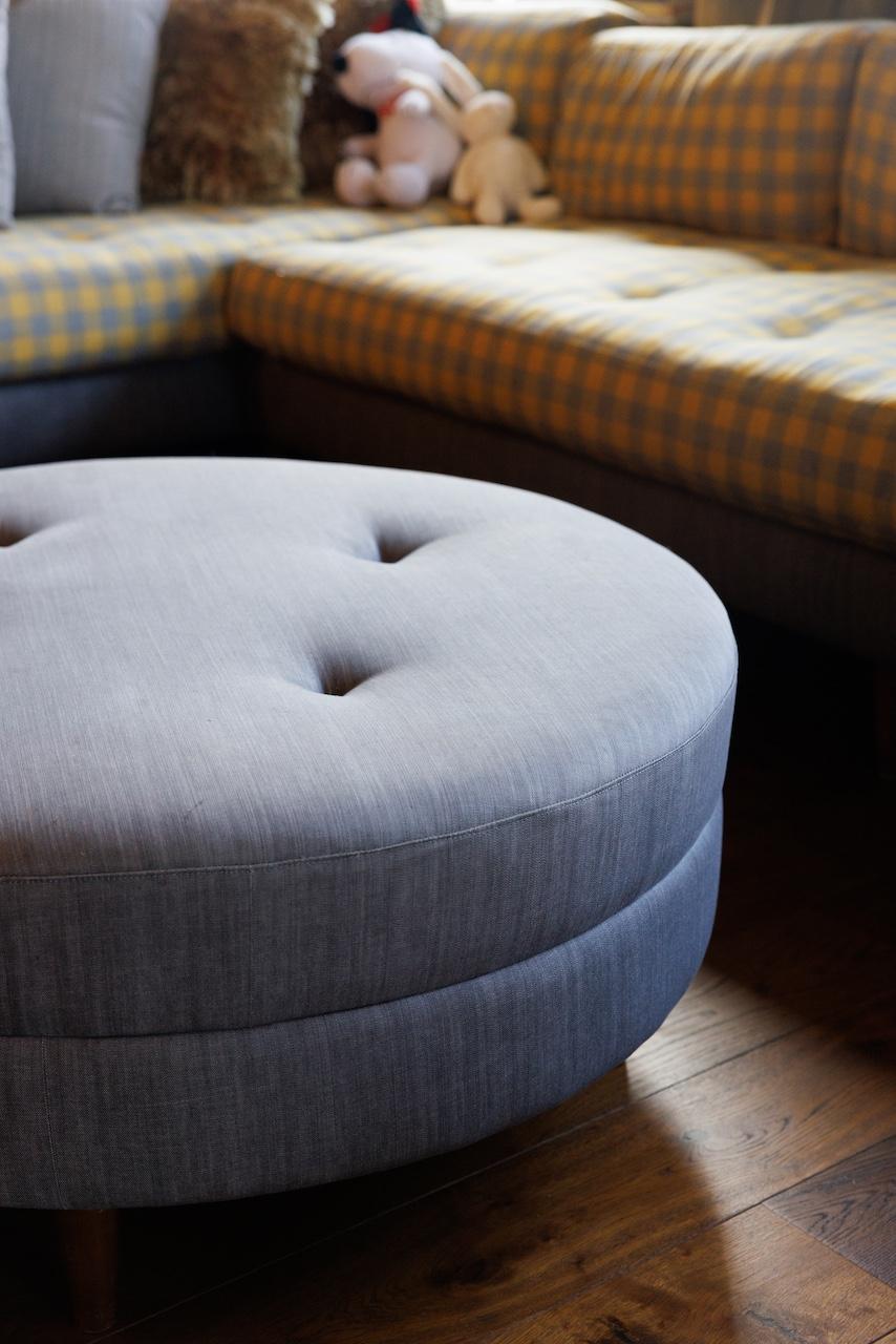 With a circular silhouette and hand-crafted button tufting on top, this blue grey round storage ottoman offers multiple functions to stylize a living space. Denim poly fabric offers a casual upgrade and complements birch solid wood legs. 

Andy