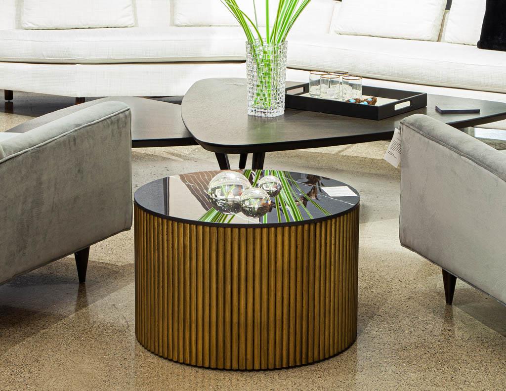 Custom round porcelain black and gold tambour side table. Beautiful Italian porcelain in black with smoked white and grey veining. Resting atop a circular tambour pedestal in a faux finished gold leaf color with antiquing details.

Price includes