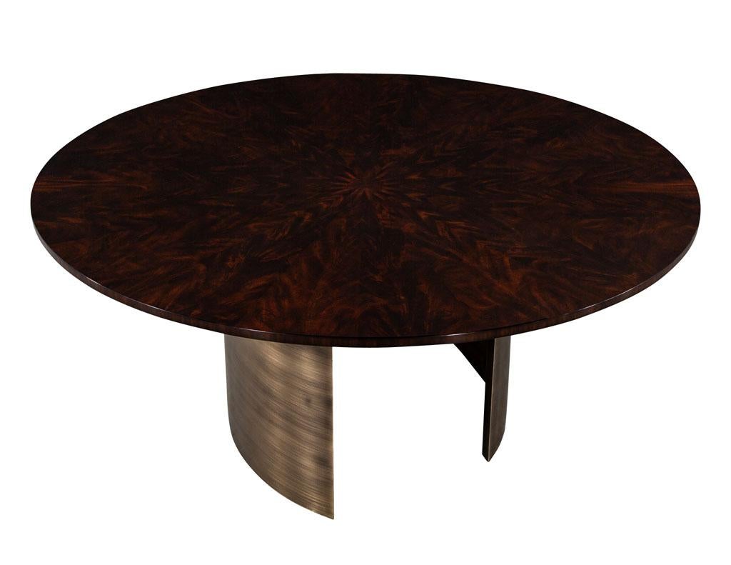 Custom Round Sunburst Mahogany Dining Table by Carrocel. Outstanding round sunburst flame mahogany top hand polished to a mirror finish in a rich mahogany tone. Perched on two custom antique brass semi-circle sculpted metal bases. A truly