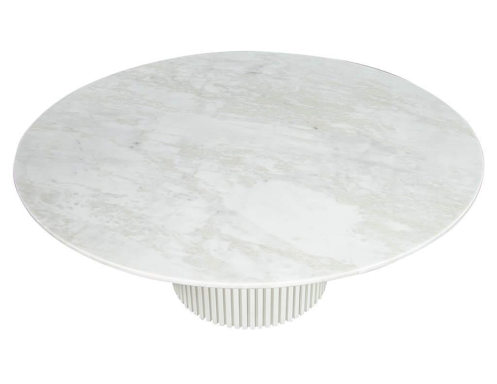 Custom round white marble top dining table. Featuring beautiful marble top with smooth edge and uniquely modern designed wood pedestal base.

Price includes complimentary curb side delivery to the continental USA.