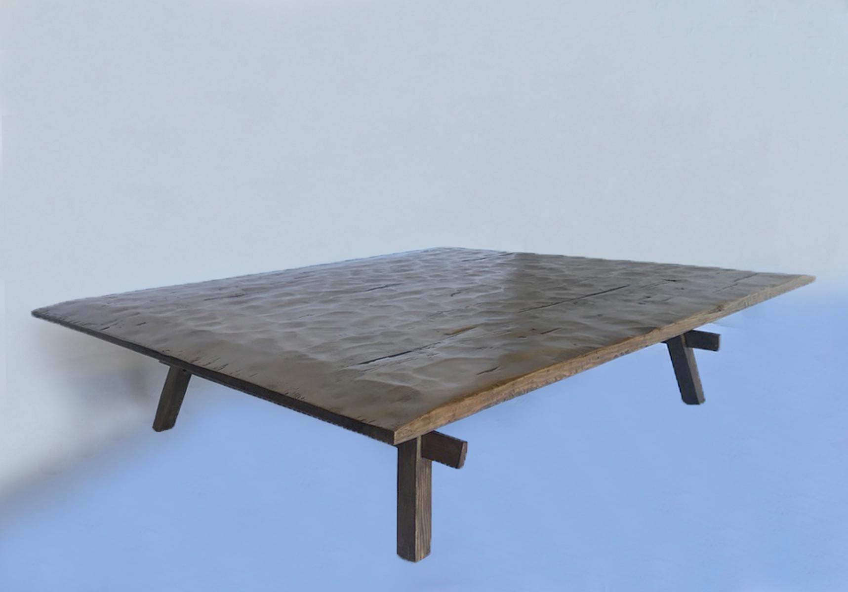 Thin profile coffee table based on a rustic antique table from Guatemala. The top is hand finished with a traditionally hand hewn top and distressed to add character. This table can be made in any size and with a variety of finishes. Made in Los