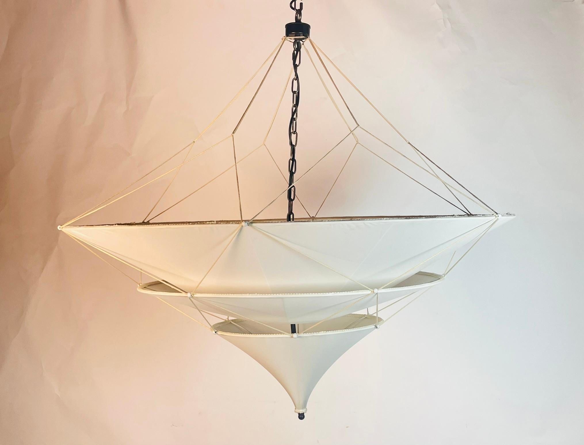 Elevate the ambiance of your space with the exquisite Custom Sabina Chandelier by Oly Studio. Crafted with a sleek metal frame and adorned with a luxurious fabric shade, this stunning piece exudes elegance and sophistication. The unique circular