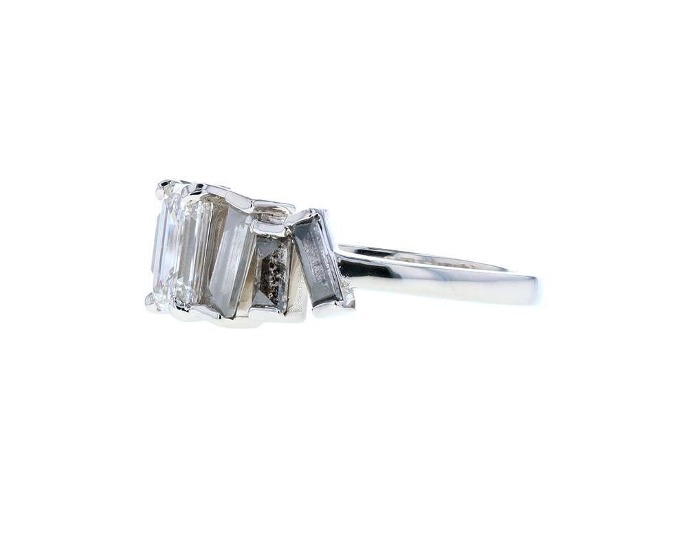 The sky is the limit when it comes to executing our clients' visions! Take for example this stunning custom emerald cut salt & pepper diamond ring with an abstract layout in the setting. Featuring a large white emerald cut center stone, the ring is