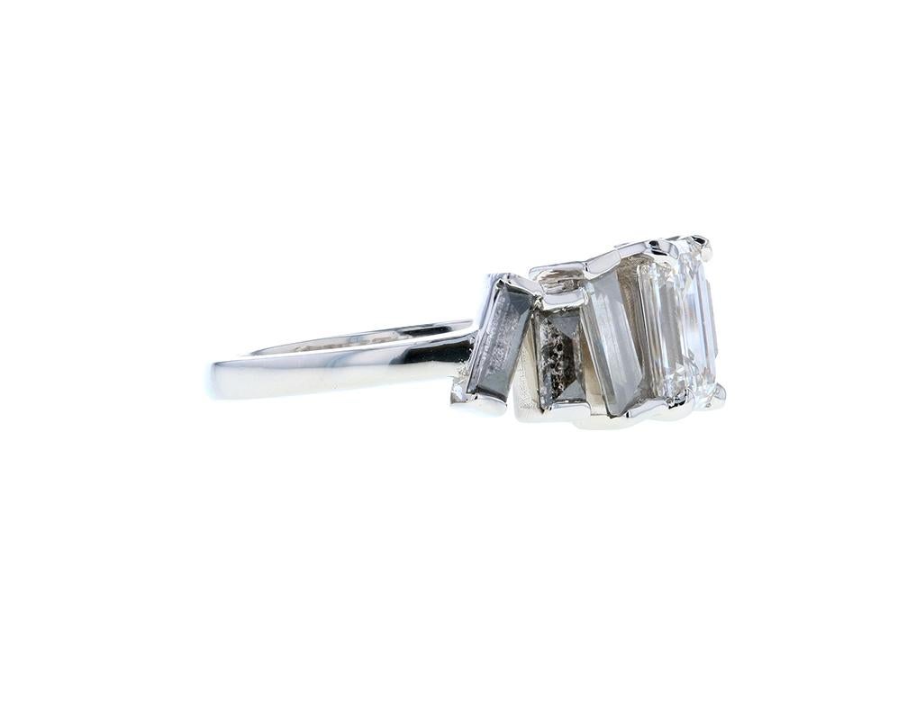 salt-and-pepper emerald-cut diamond surrounded by a halo of baguette-cut white diamonds