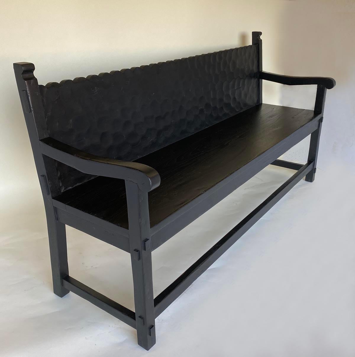 Custom bench with scalloped back shown here in Walnut. This can be done in any size and Walnut or Oak in any finish, please see attached sample board. Shown here with a hand hewn back, this is optional. As shown in ebony finish with a medium