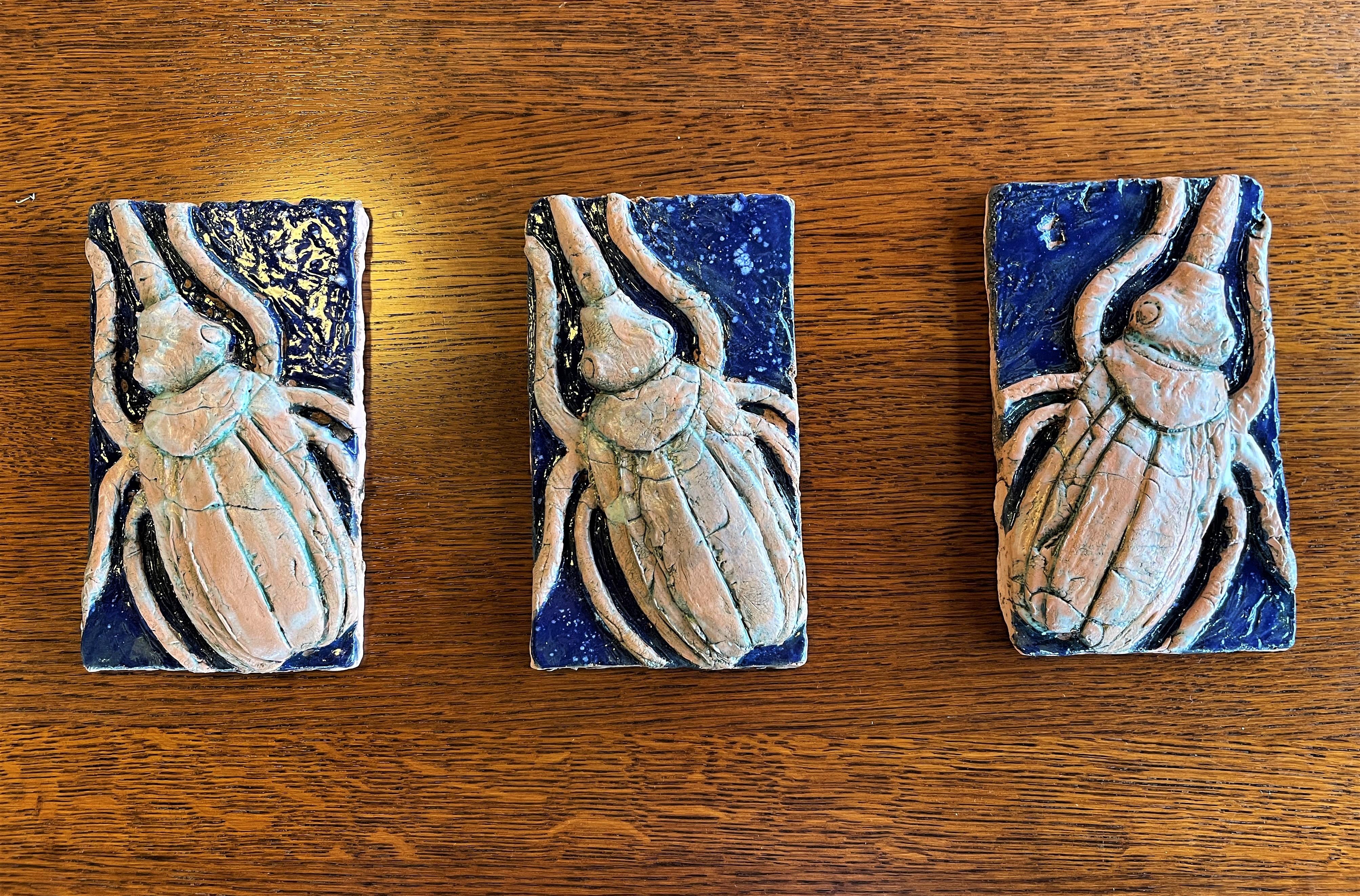 If you love scarabs, this set of 3 hand-crafted bas-relief ceramic tiles would make a unique addition to your collection. You won't find another like it! That they are a set of three makes them versatile as wall-tile accents or incorporated into a