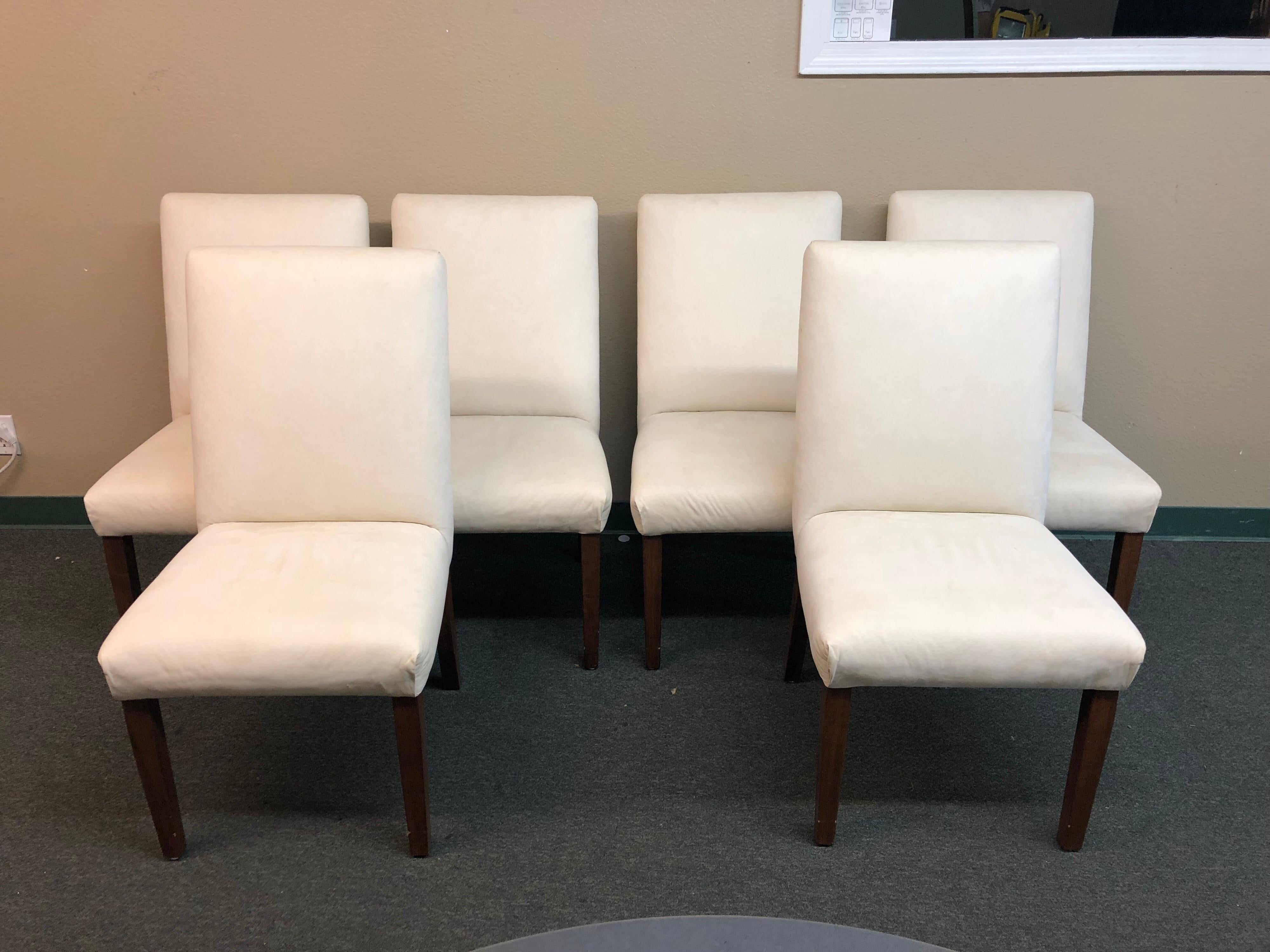 A custom set of dining chairs. Six beautiful ivory suede seats sit on tapered espresso legs. A lovely neutral set of chairs for your stunning table.
 
