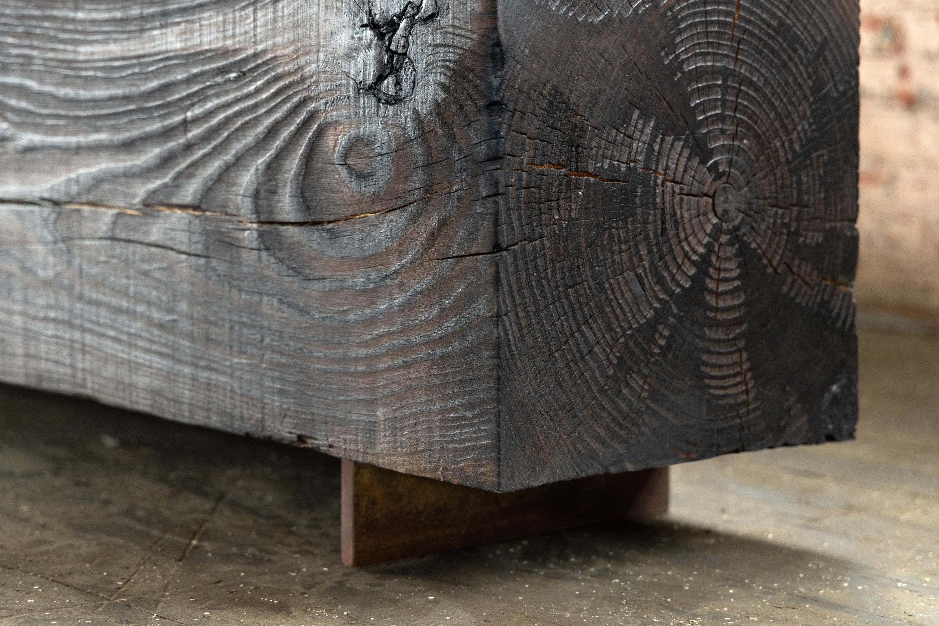 Our beam bench utilizes urban, local pine logs for a solid volume bench for indoors or outdoors. Narrow and backless, the simple lines express the graphic texture of the end grain of each log. The 15