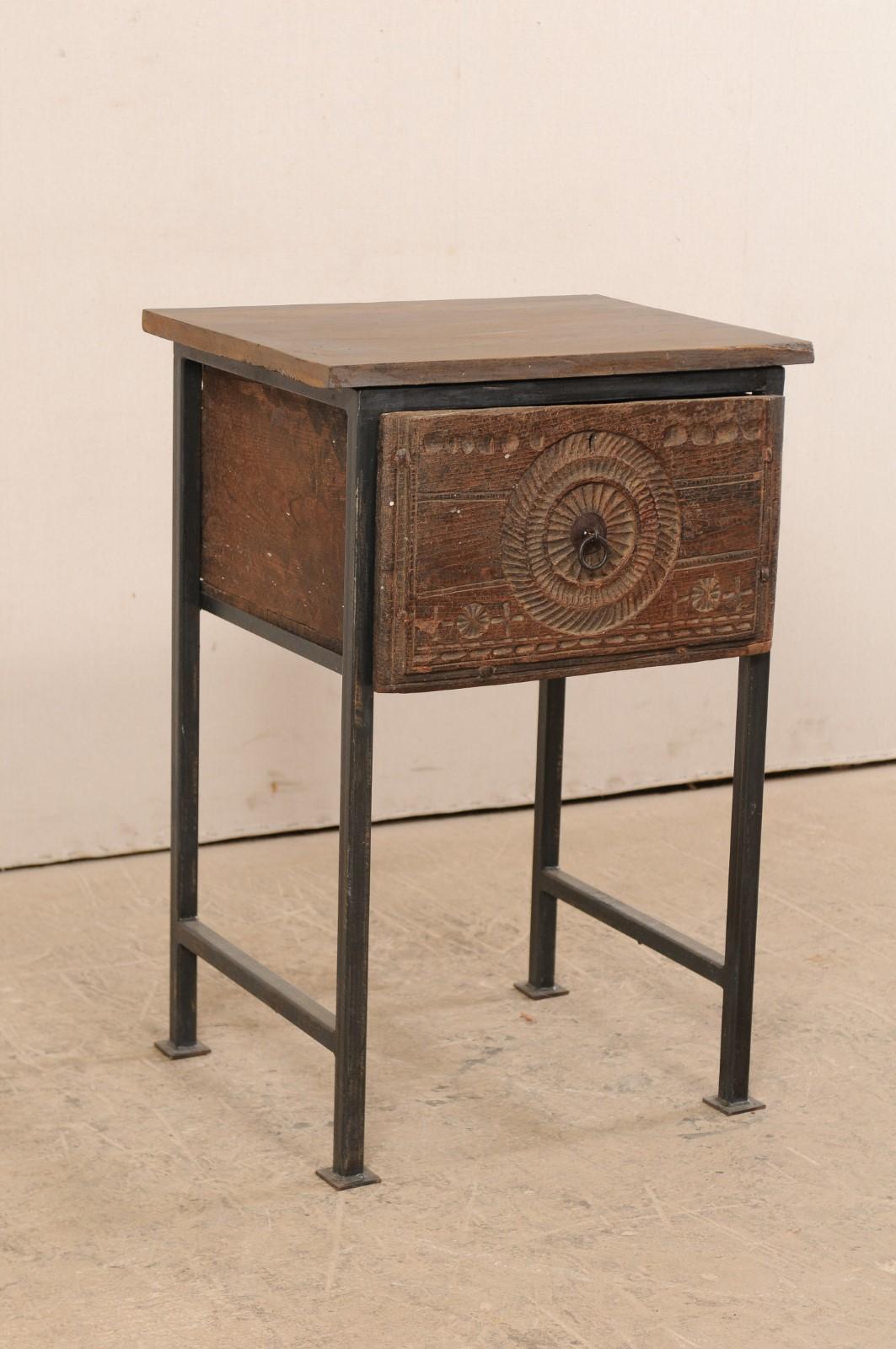 A smaller-sized side chest with 18th century Spanish door. This unique and custom designed side chest features an 18th century (or earlier) carved wood drawer from Spain, which has been topped with reclaimed wood above, and set within a custom iron