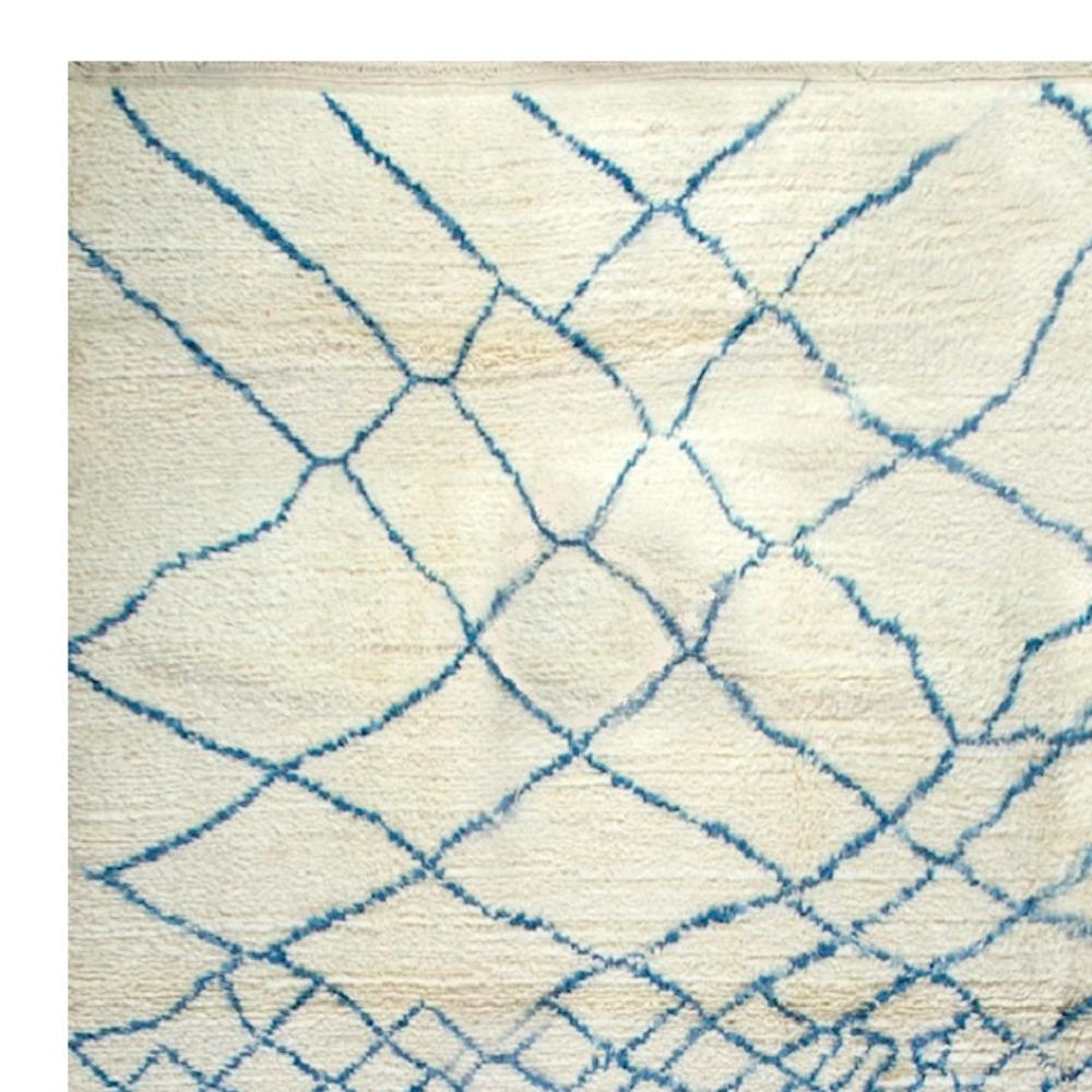 A contemporary hand knotted Moroccan rug inspired by the Berber culture in the Atlas mountains, with soft velvety pile, made of hand-spun natural lambswool. It has an overall lattice design changing in size and look from large and billowing at the