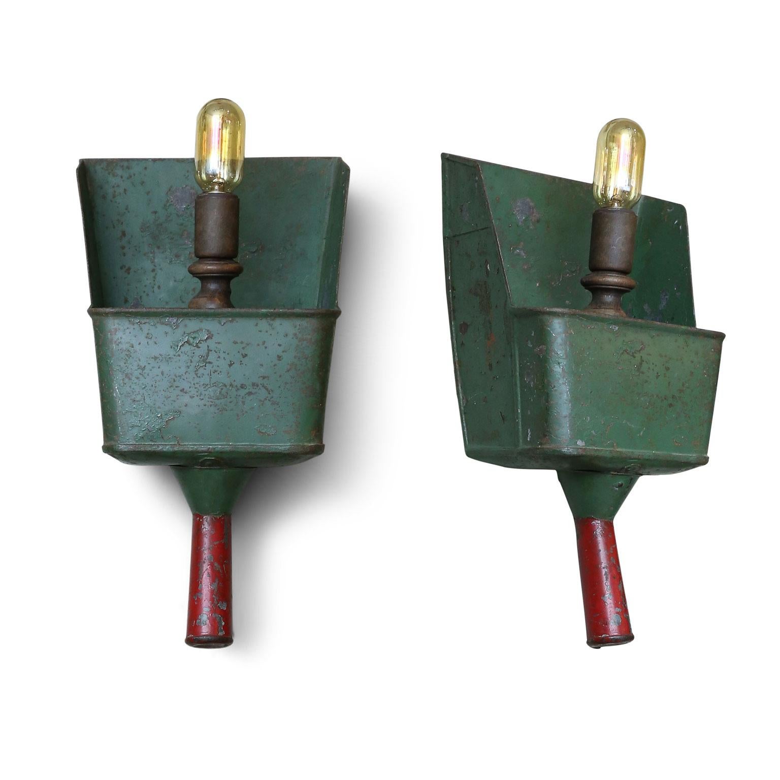These sconces are surely unique and could be interesting for a rustic or primitive interior. They are original green and red paint with turned wood socket.
They have been made and newly wired in the US. The scoops themselves are circa 1920 and were