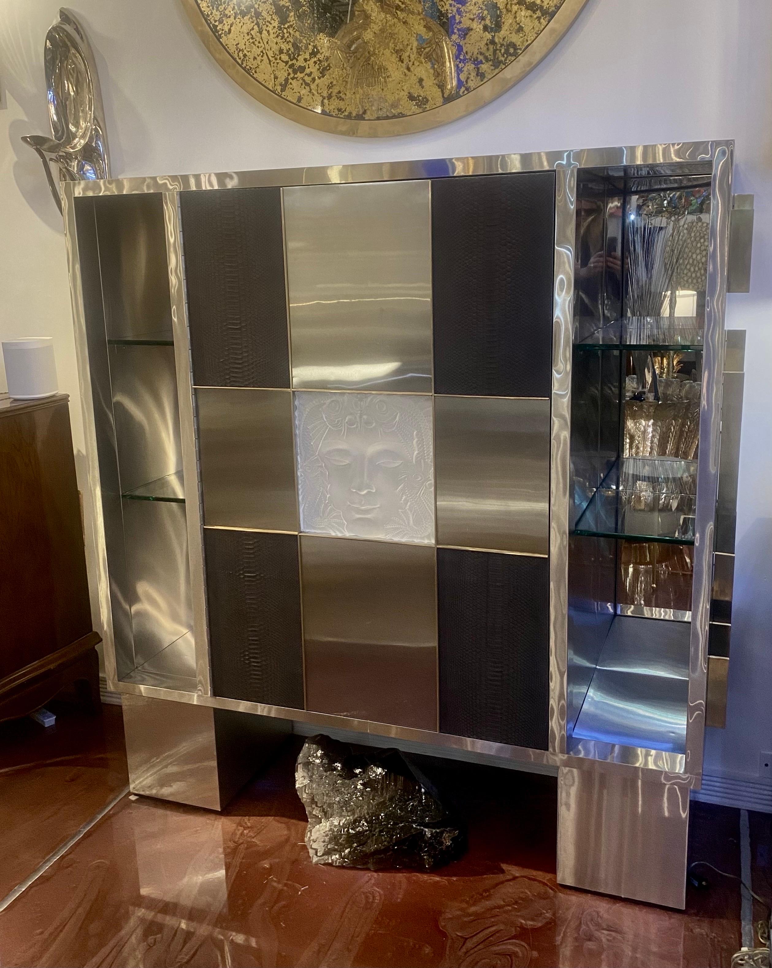 Un bar seco o mueble a medida de acero inoxidable, pitón negro, latón y cristal art déco con estantes de cristal e interiores de espejo. Este artículo fue creado para exponer el centro de mesa de cristal art déco hacia la década de 1980, por una