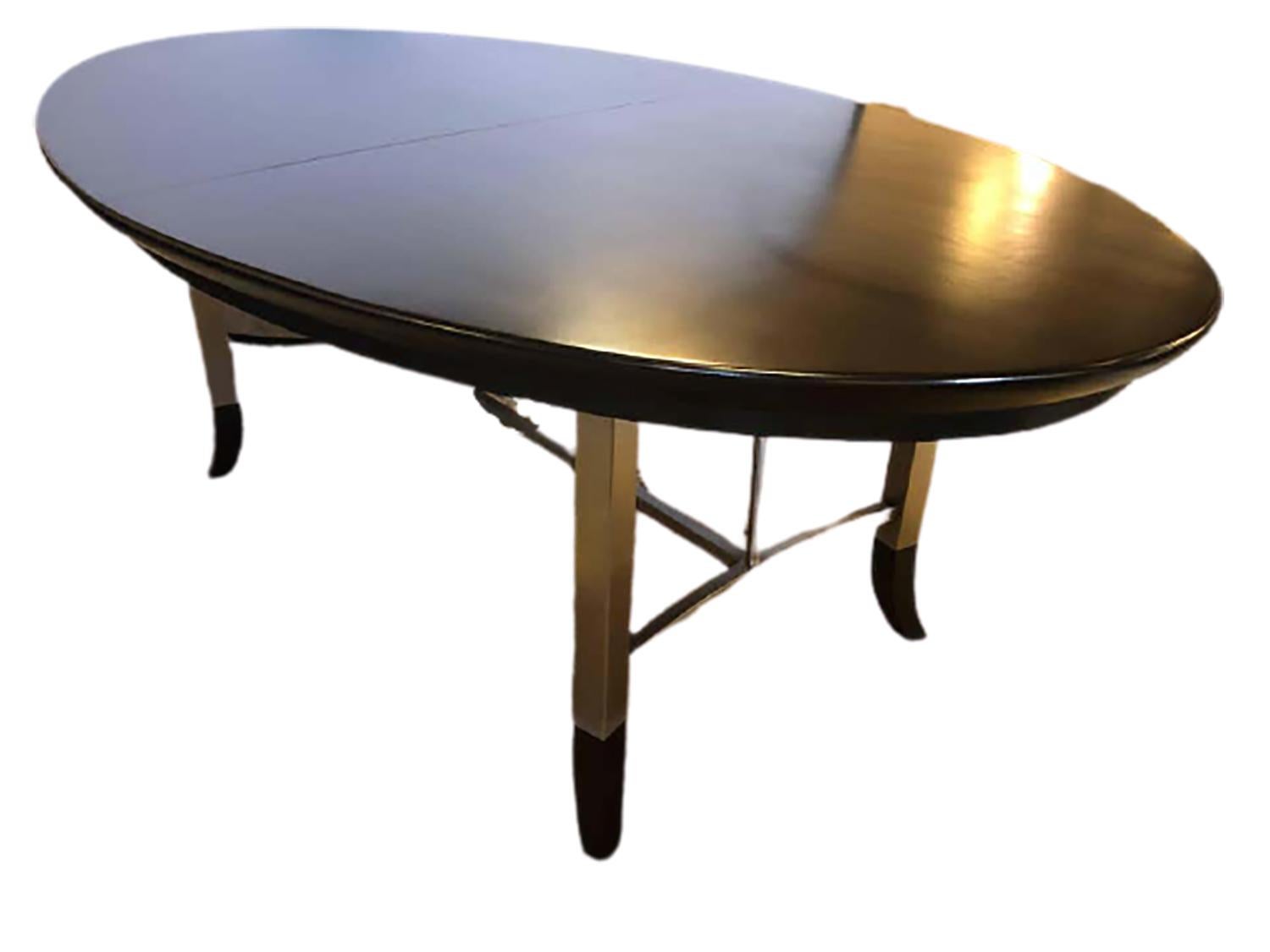 Custom-made modern steel and ebonized oval design dining table with matching ebonized sabots. Part of our extensive collection of over forty dining tables and chair sets as seen on this site, thus why we are referred to as the King of Dining