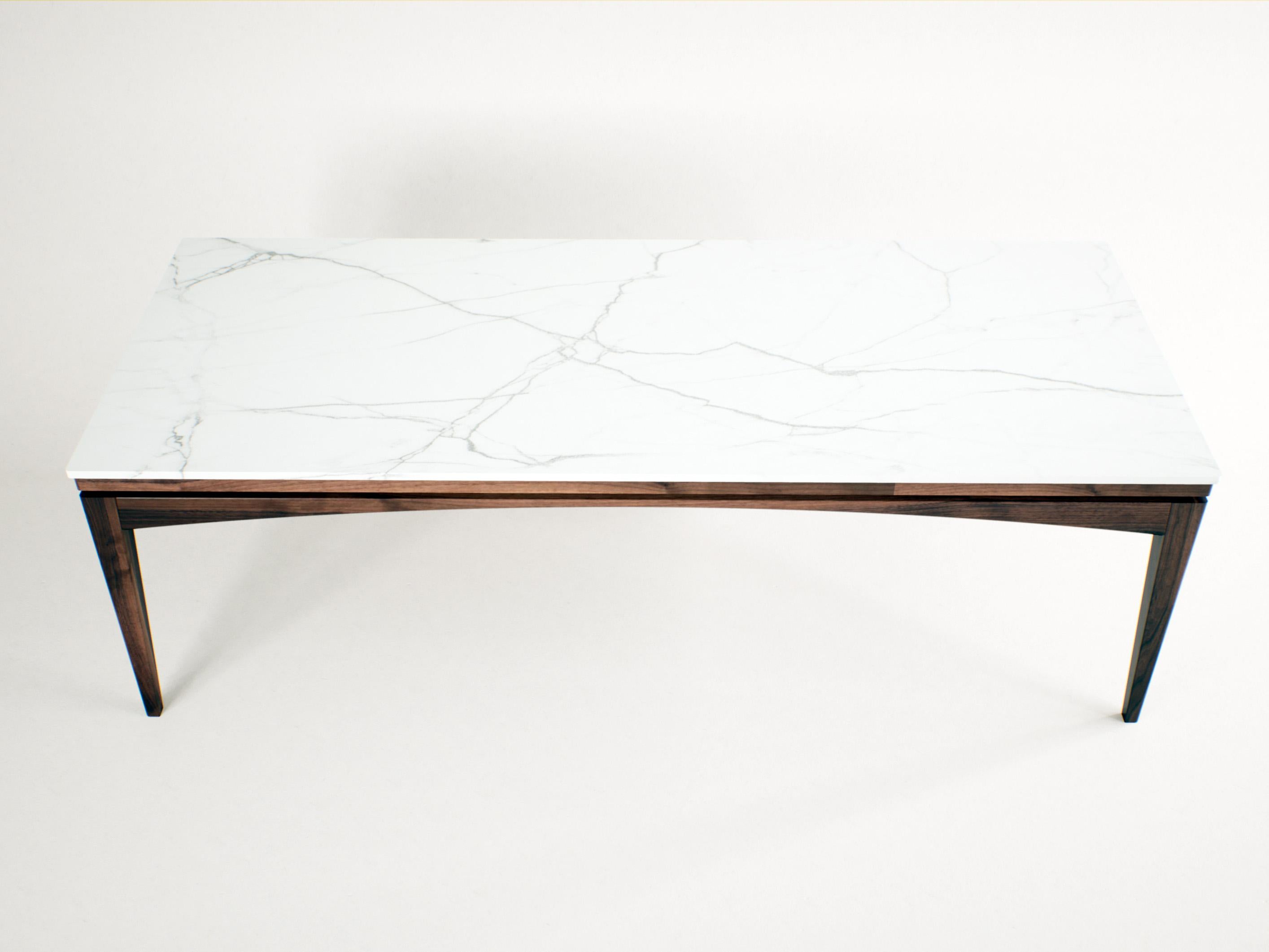 Dining Table with White Porcelain Top and Sculptural Solid Wood Base

This dining table merges the elegance of marble-inspired porcelain with the warmth and presence of handcrafted woodwork (American walnut). The veined white porcelain surface