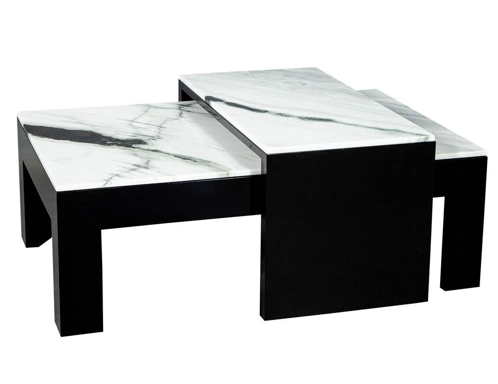 Custom stone top nesting coffee cocktail table. Finished in a hand polished black lacquer and exclusive stone tops. Table has an extending gliding section for serving and extra space. Size: Nesting table W 20”, H 21”, D 38”
Price includes
