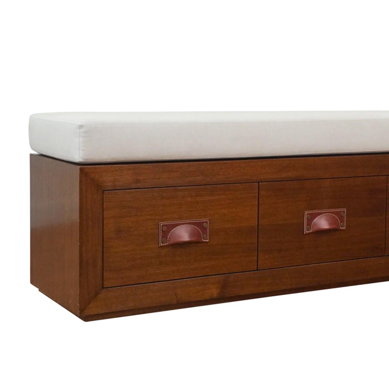 Custom storage bench on plinth base with leather pull hardware. Shown in medium walnut and upholstered in a natural linen fabric. Also available in white or black lacquer, light cerused oak, and oil rubbed teak.

COM: 5 yards
Lead Time: 6-8