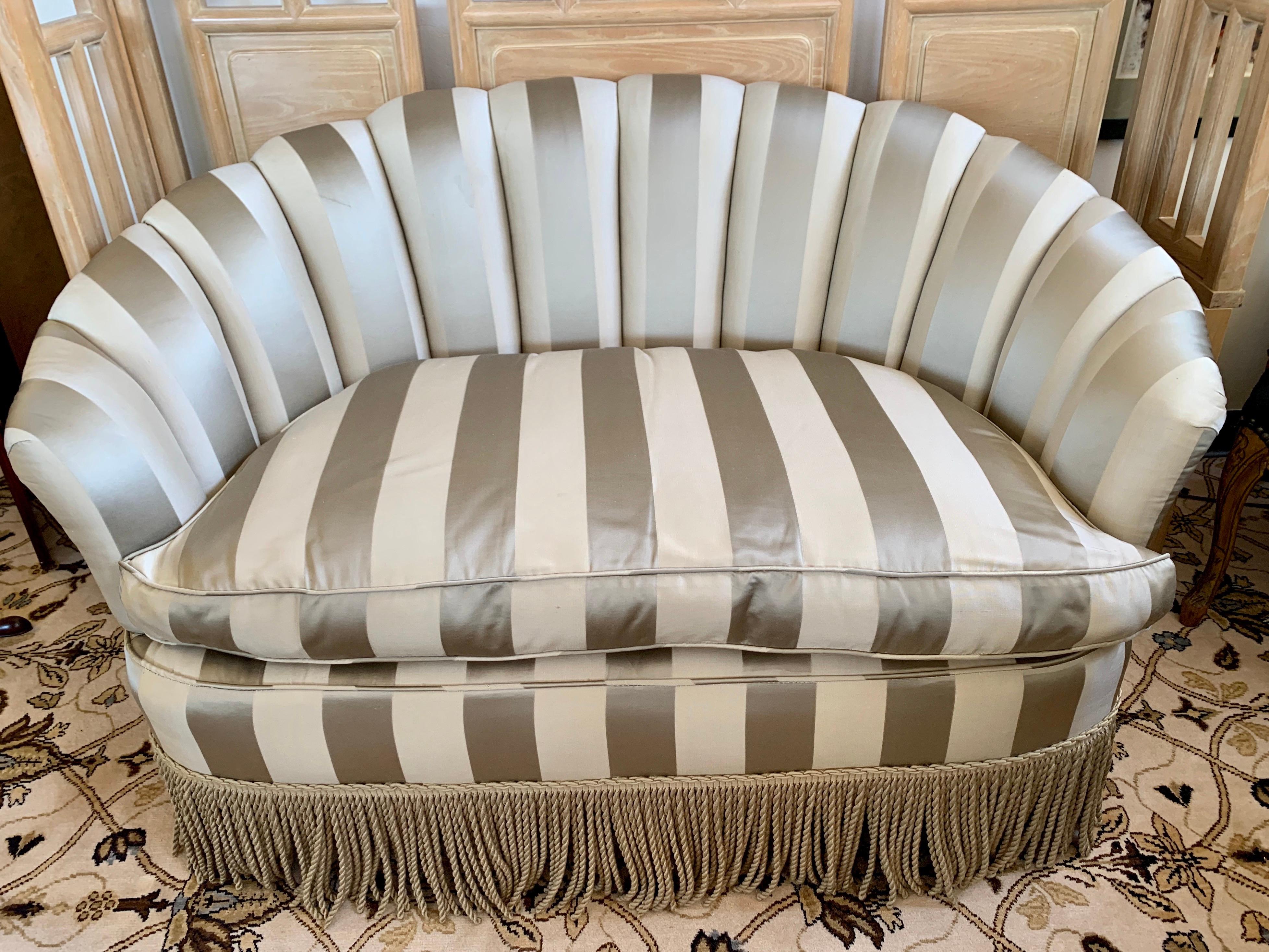 Impeccably upholstered silk striped curved loveseat with channel back and coordinating tassel fringe.
Features 8-way hand tied construction for the perfect level of comfort and support.
 