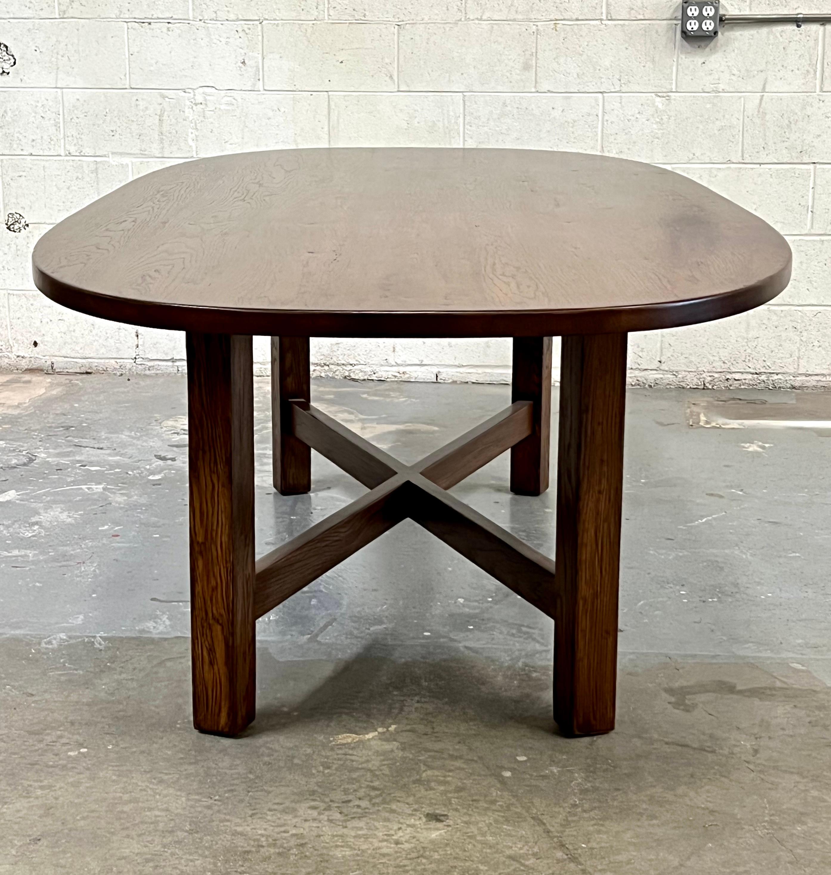 This custom X base oak dining table with a super ellipse top is seen here in 102