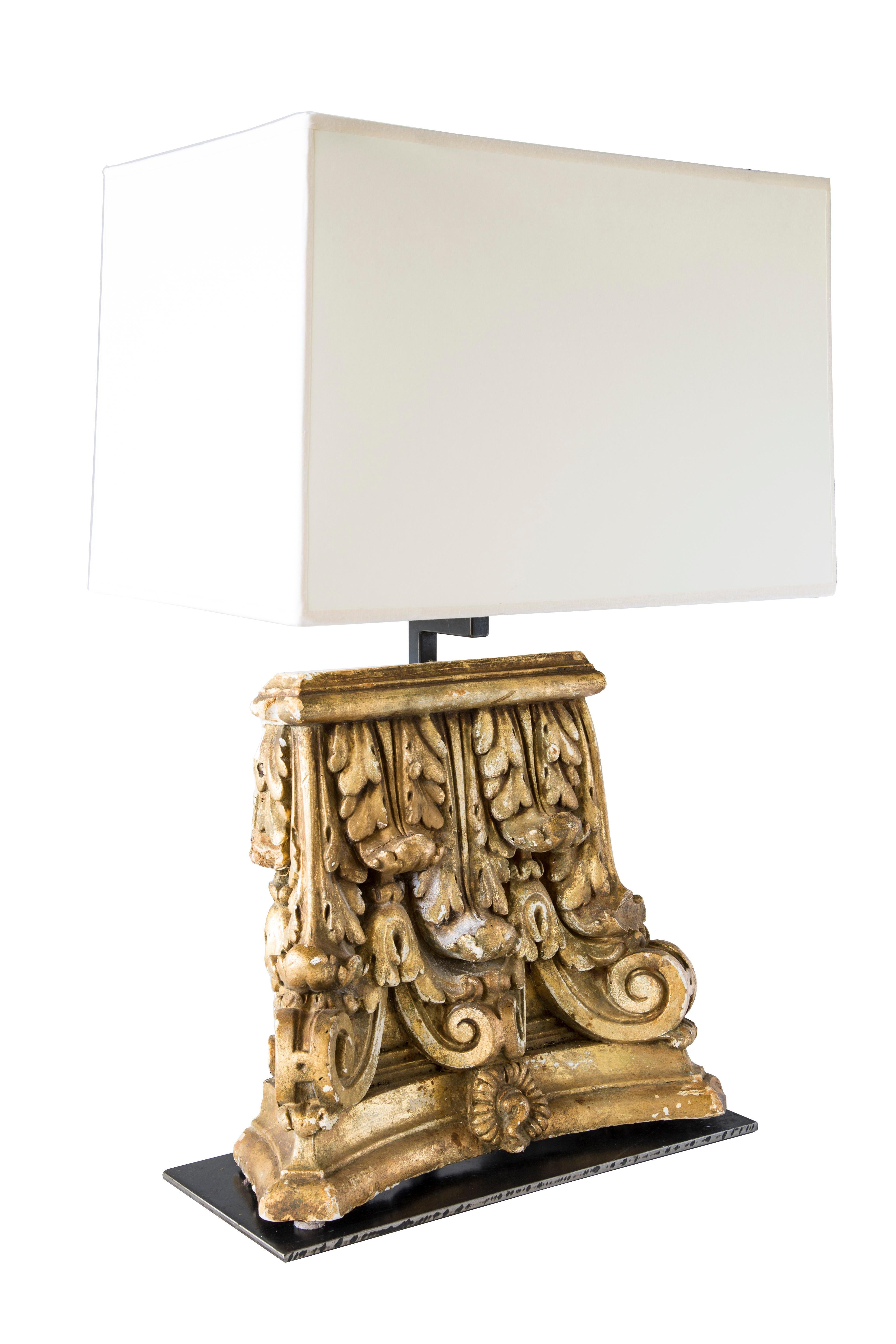 Custom table lamp with gilded capitol fragments.
