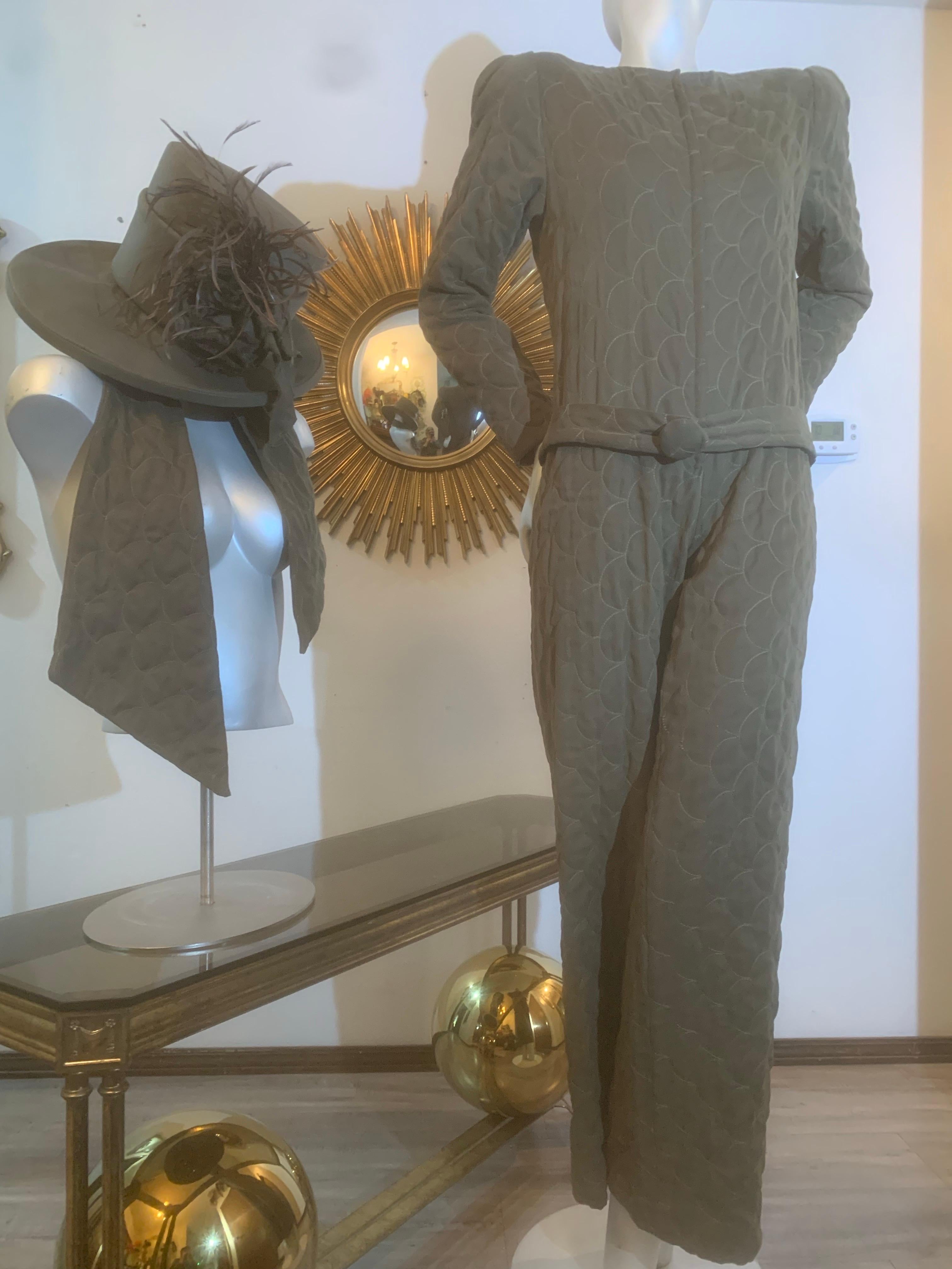 Custom-Tailored Olive Green Ultra-Suede Jumpsuit w Matching Hat & Scarf Ensemble:  Lightly padded and quilted ultra-suede jumpsuit in an ultra-fitted silhouette. Crew neckline, zippered front and fitted sleeves.  Wide leg w weighted hemline for good