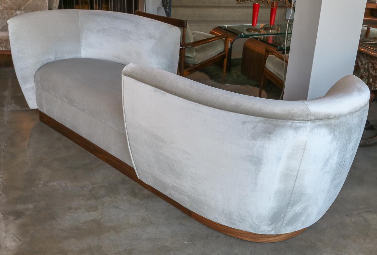 Custom tete-a-tete sofa bench in grey silk velvet with American walnut wood base.  Made in Los Angeles by Adesso Imports. Can be done in different fabrics, colors, sizes and woods.

Length between the arms: 51