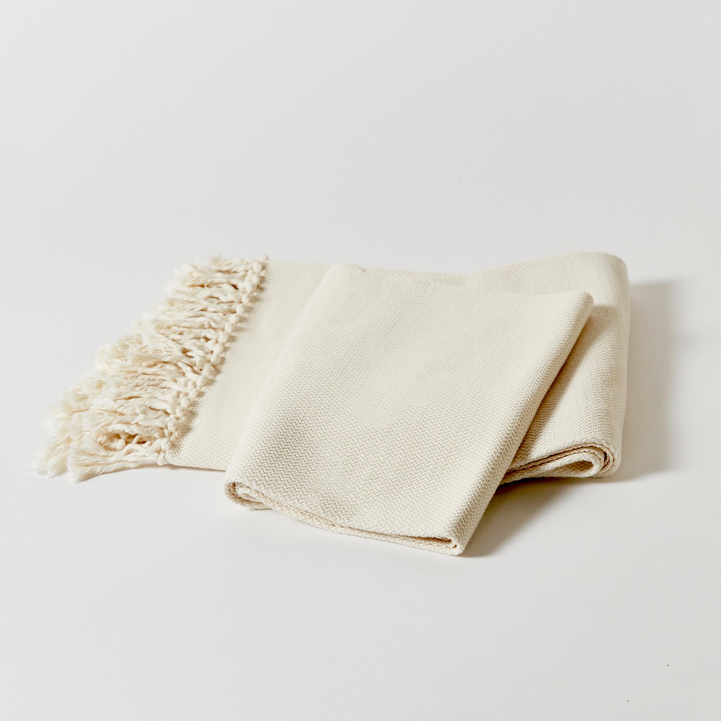 Hand-Woven throw with natural fringe. Made in Argentina with pure handspun cotton.