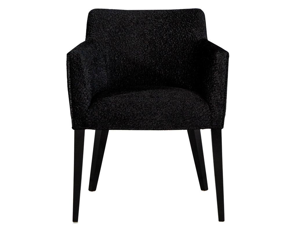 Custom Tonio modern dining chairs by Carrocel. Finished in a hand polished black lacquer and upholstered in a rare designer black Faux Lambs Wool covering. Frames are made of solid hardwood.