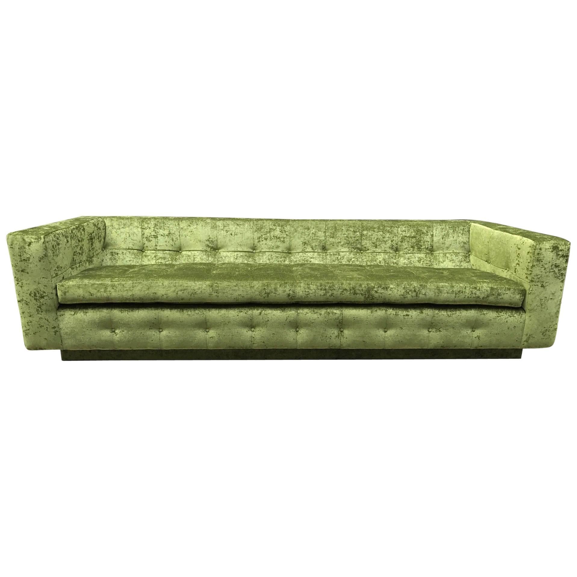 Custom tufted sofa newly upholstered in green velvet on a plinth base. Has loose seat and side cushions.
The sofa shown is available now.