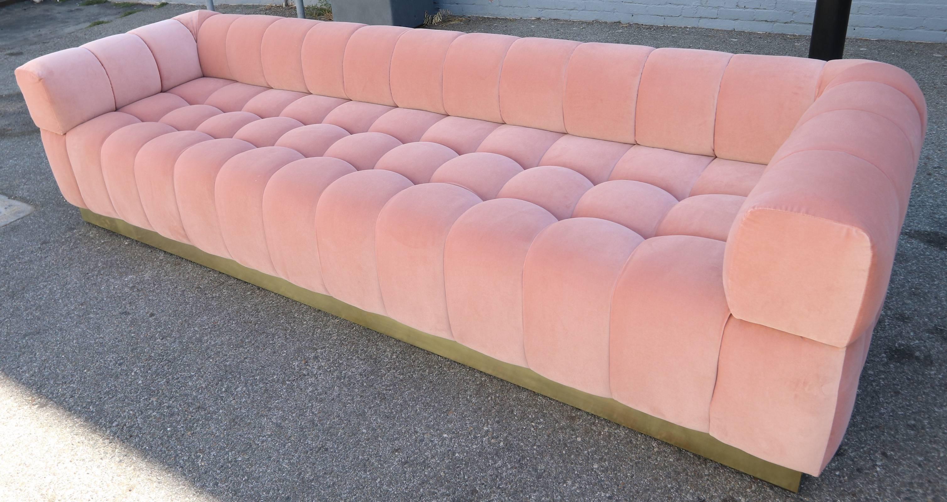 Custom tufted sofa with handmade brass base, in apricot pink velvet.  Made in Los Angeles by Adesso Imports. Can be made in different colors and fabrics or a different metal for the base.