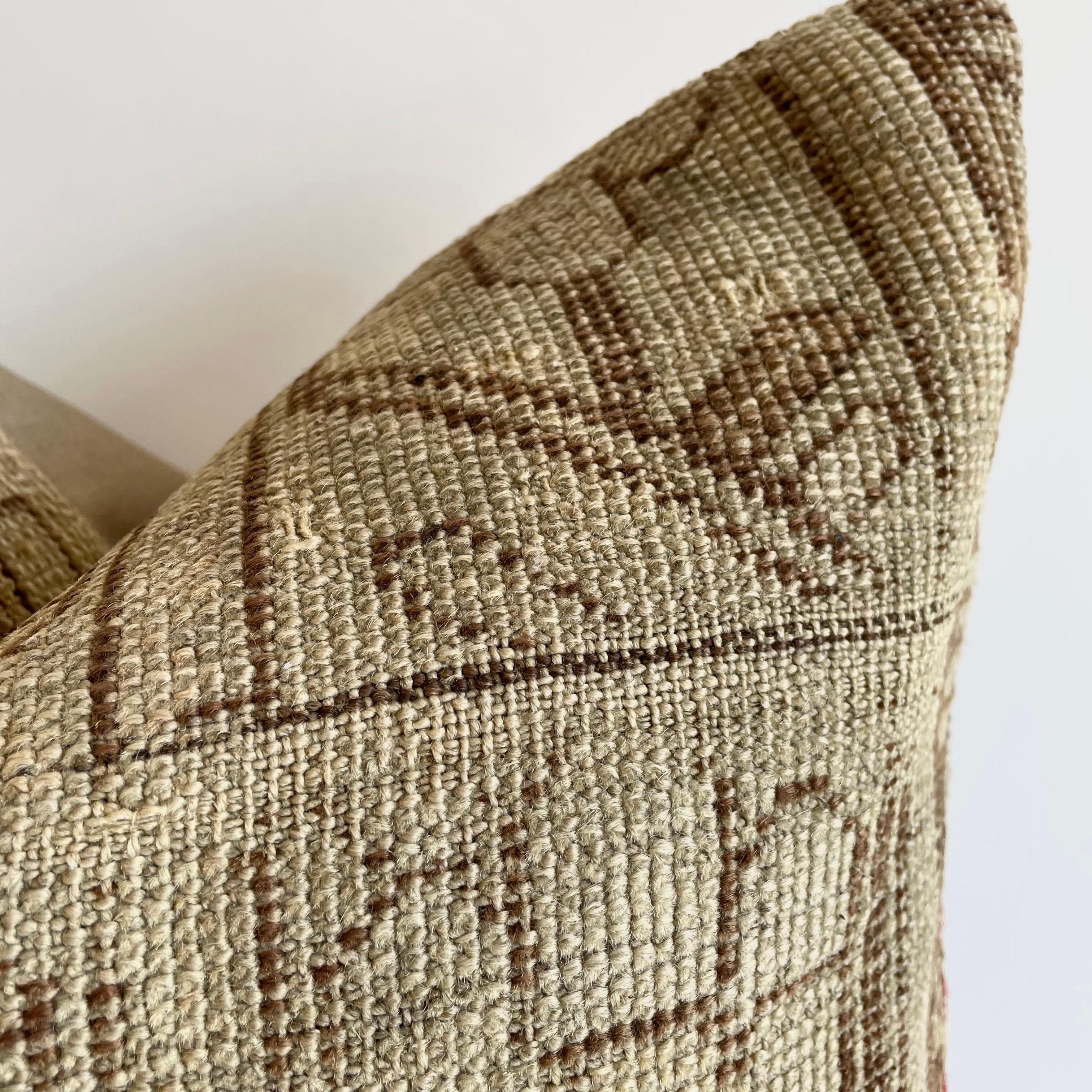 Antique woven rug pillow in natural gray brown and taupe with geometric patterns. The backside is a coordinating cotton. Our pillows are constructed with vintage one of a kind textiles from around the globe. Carefully constructed with the finest