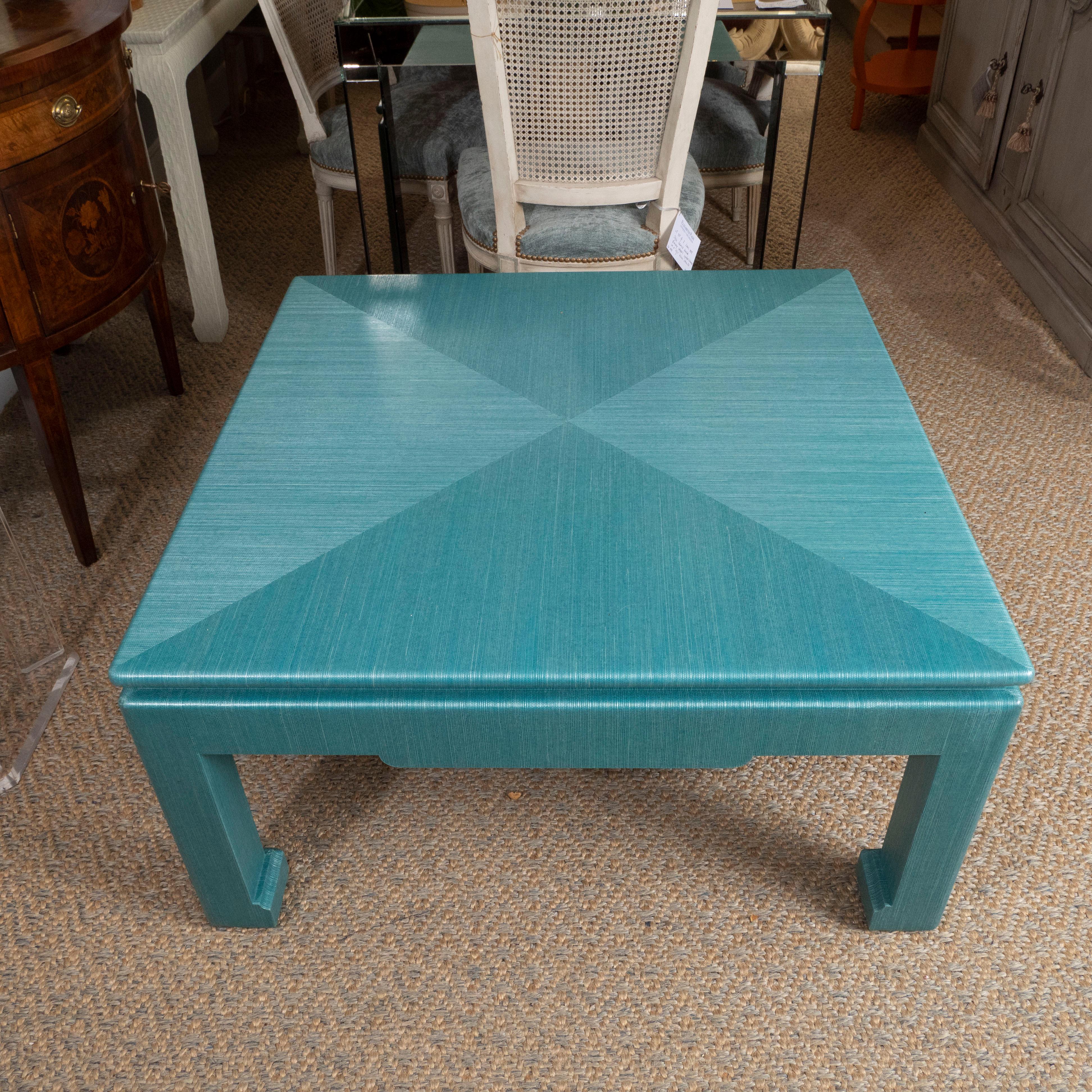 This table will add color and style to a space! In the Asian style, this piece has been beautifully wrapped in a turquoise grasscloth. Perfect for a living or family room, this piece has form and function!