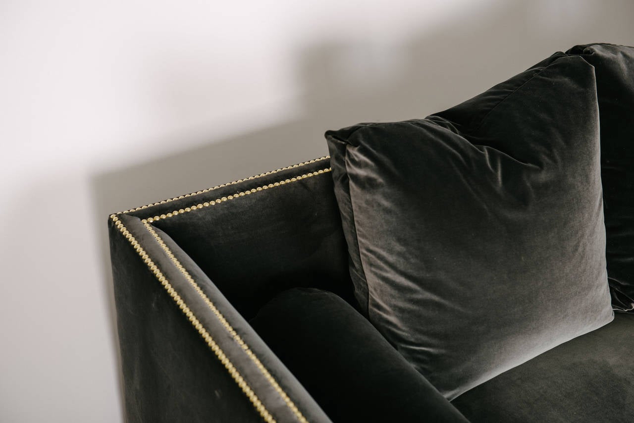 Our in house custom built tuxedo sofa is fabricated with an eight-way hand tied hardwood frame and the seat is a down feather wrapped high quality spring coil cushion. Shown in an anthracite charcoal gray velvet. Available C.O.M. and in other