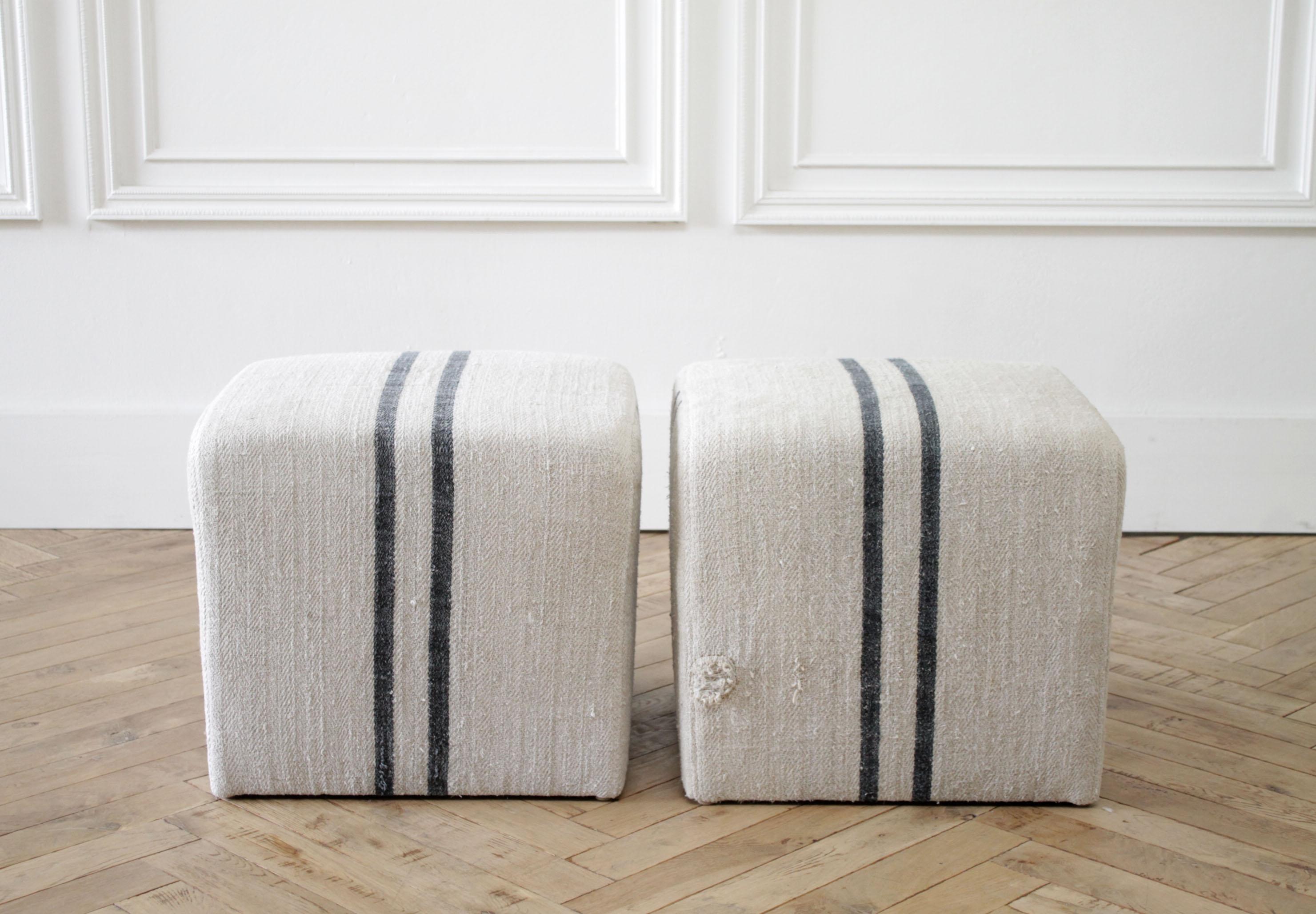 Custom upholstered cube ottomans in natural grain sack with black stripe
Fabric is vintage, one of a kind. These European Grainsacks or farm bags were used to hold grains, and have original
patches, stitching, and other markings. Each one is very