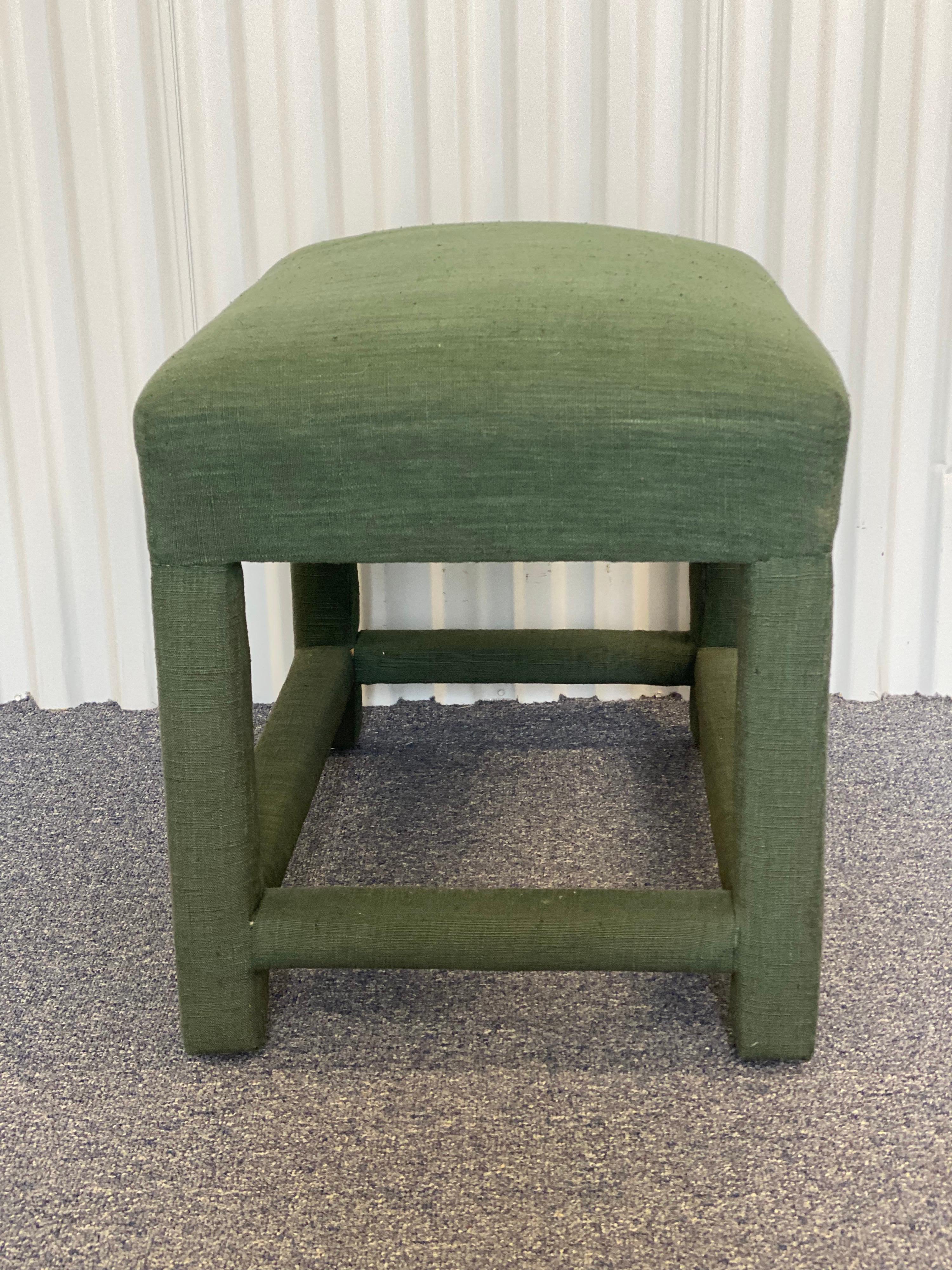 Custom Upholstered Green Linen Wrapped Stool
Parsons style simple clean lined design, wrapped and hand-sewn at the corners. 
Some very slight separation of the fabric where it wraps around the legs and slight fading, otherwise good condition.


