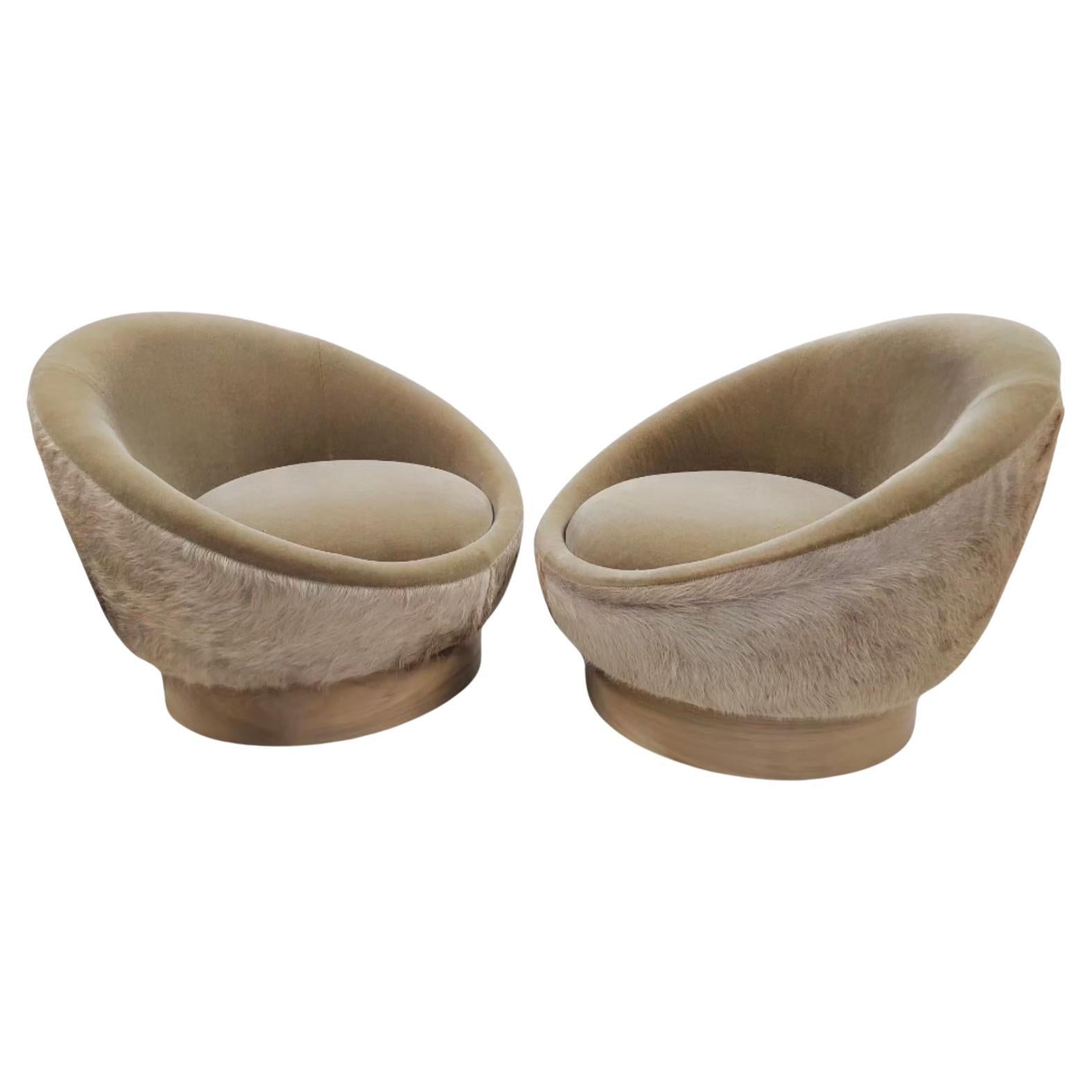 Vintage Modern Swivel Pod Lounges Newly Custom Upholstered in Plush Camel Mohair with Brazilian Hair-on Cowhide - Pair 

The Vintage Modern Set of Swivel Pod Lounges Newly Custom Upholstered in Plush Camel Mohair with Brazilian Hair-on Cowhide is a