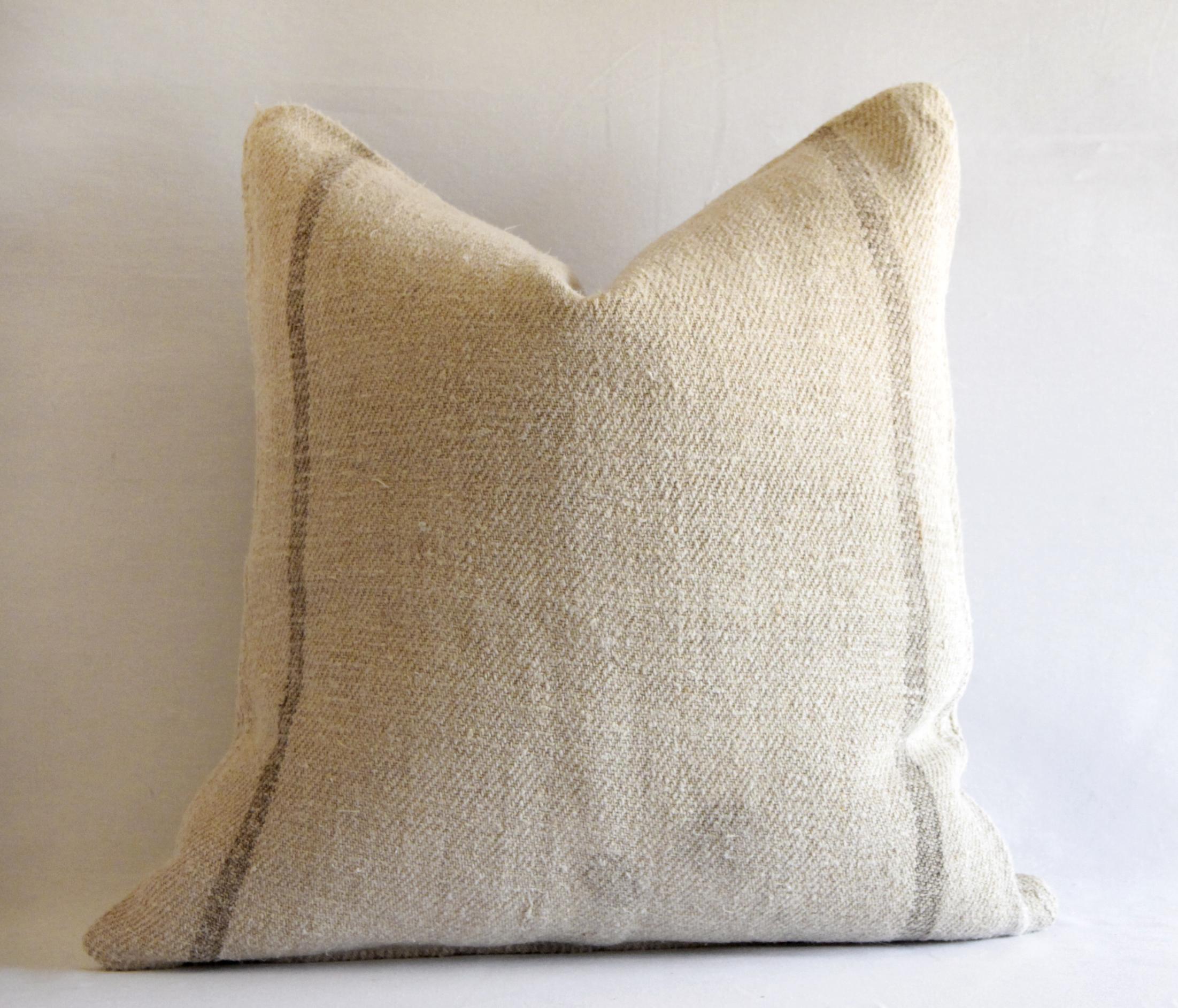 Custom vintage grain sack pillow with brown stripes
European grain sack pillows pre washed to soften them, with hidden zipper closure. The background of the fabric is a thick nubby texture, in a warm tan color, with tan-grey stripe.
Measures: 21