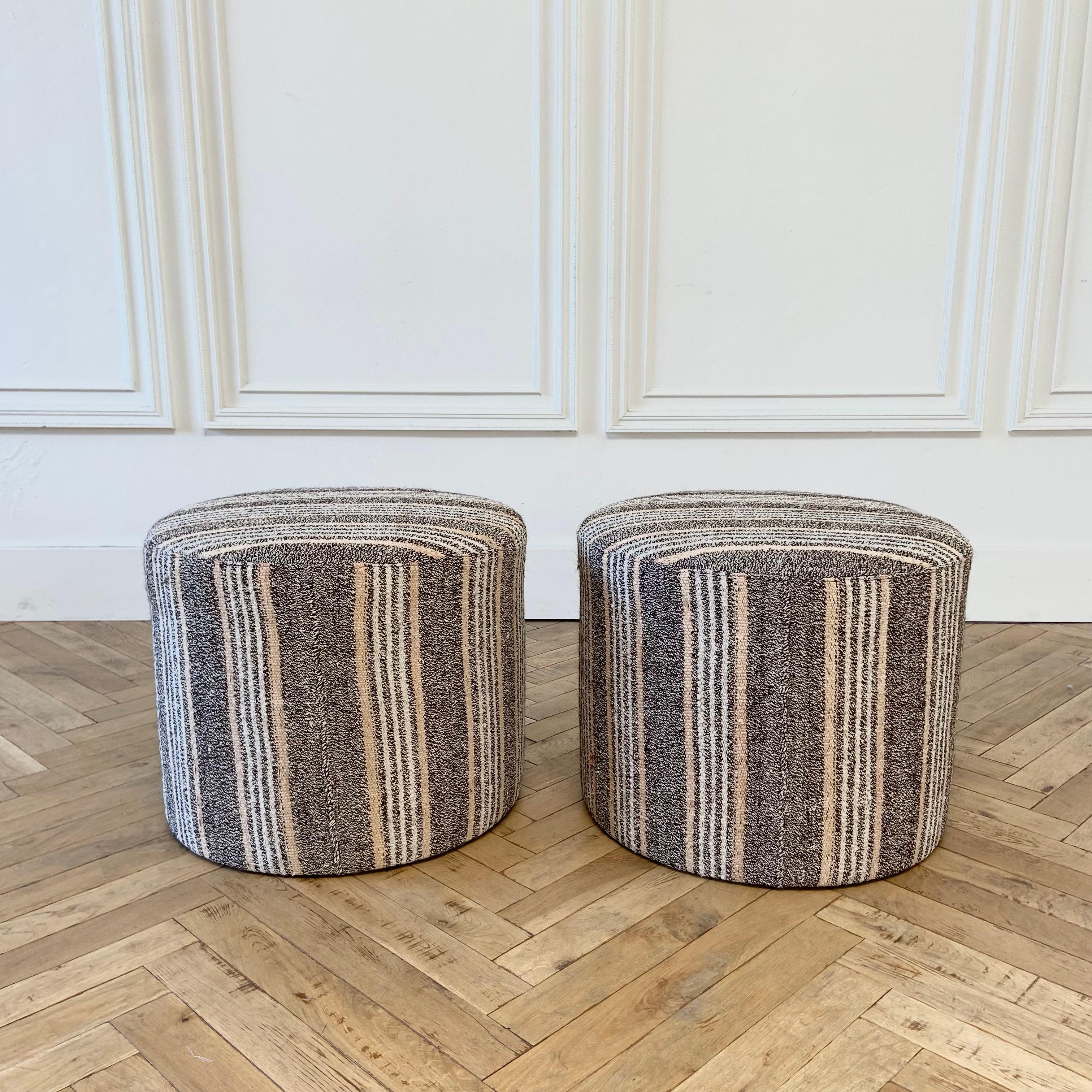 Custom made vintage Turkish rug round cocktail ottoman coffee table
Once a stripe rug now a useful cocktail ottoman. Wool and goat hair rug in a greyish, brown, golden tones with white woven striped pattern,
Also available in multiple colorways