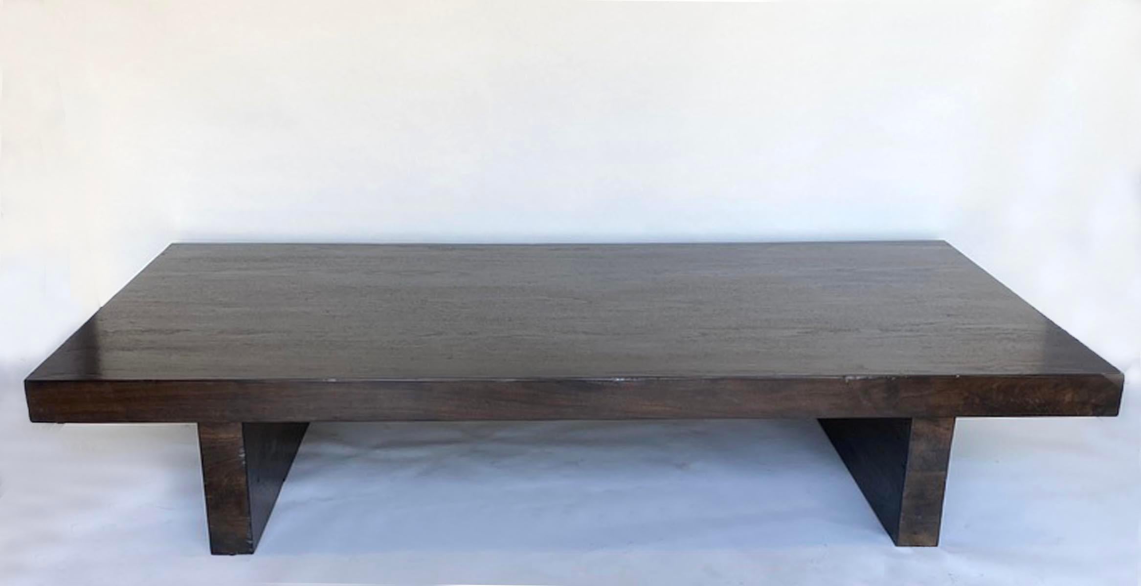 Custom low profile thick slab modern coffee table. As shown in Walnut with a custom medium to dark finish and light distress. range of colors. 
Bench made and hand finished in Los Angeles by Dos Gallos Studio.
DUE TO CHANGING PRICES OF WOOD AND