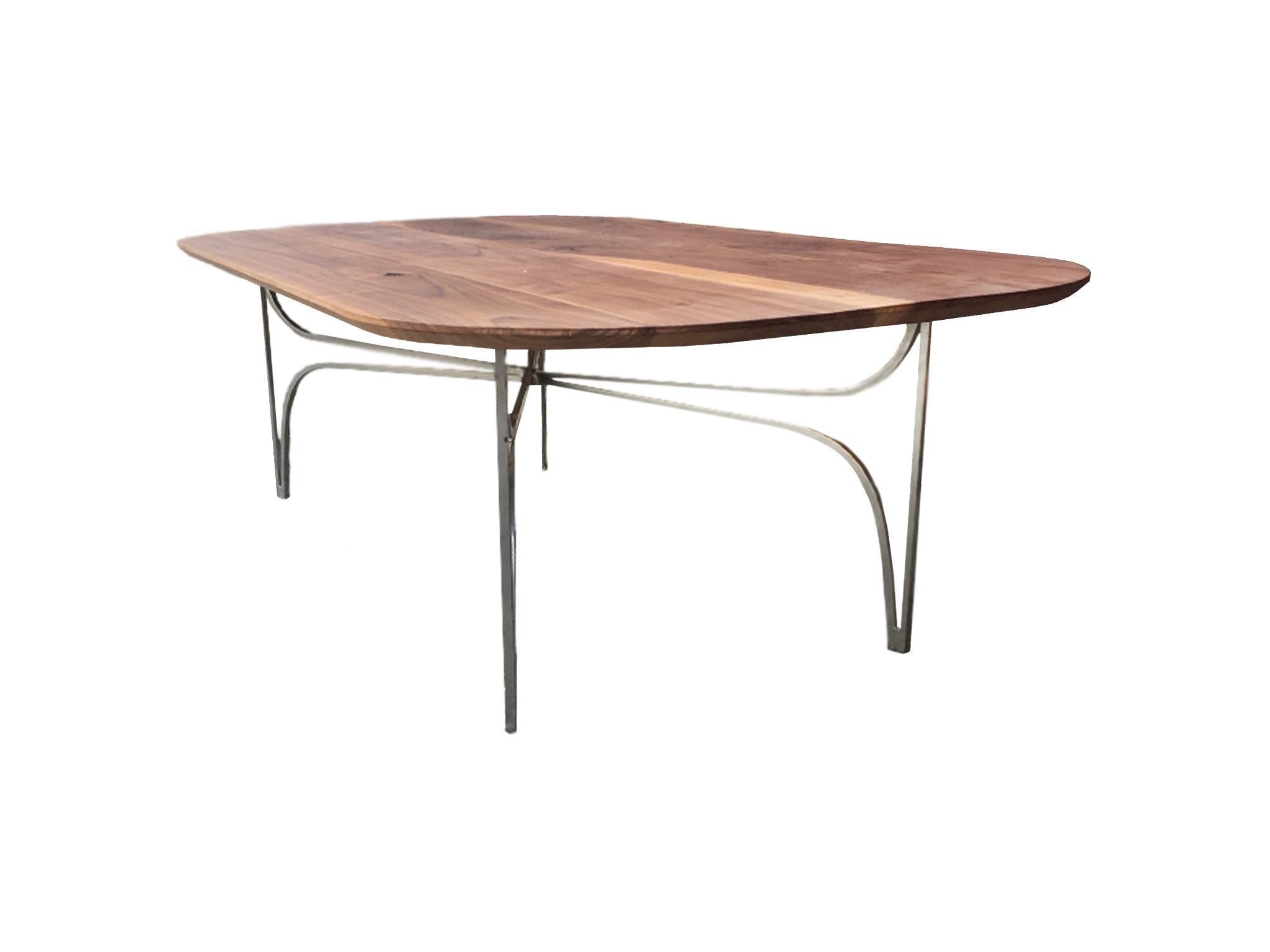 An elegant, custom made coffee table by Moni Abbasi from Hudson & Scout, a bespoke woodwork and carpentry shop. It is comprised of a vintage metal base and new walnut top handcrafted into a racetrack shape. The base is newly powder-coated. Clean,