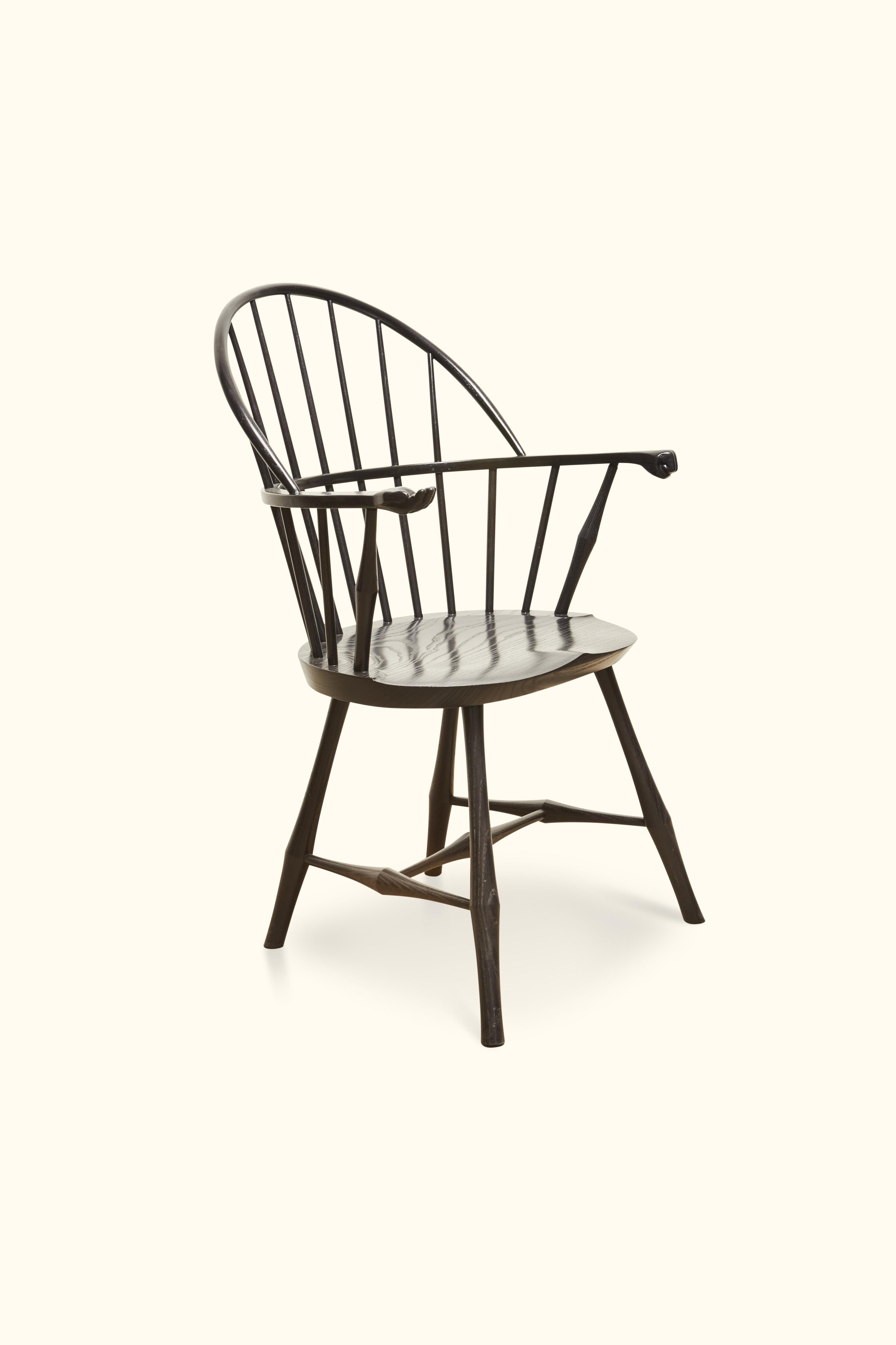 Hand carved fist and palm have been added to this one of a kind windsor chair. The Wayland sack-back armchair has a comfortable hand-shaped saddle seat and supportive back.