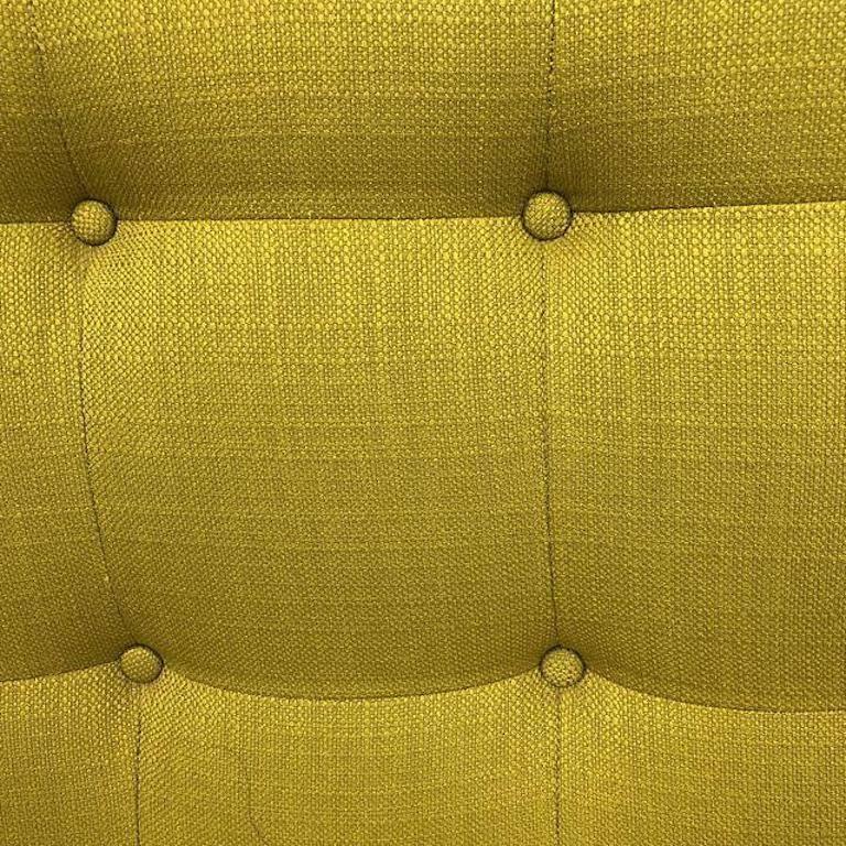 A custom Whitaker style sofa. In the style of Jonathan Adler. A flared silhouette with luxe button-tufting on tapered wood legs. Simple, soulful, and sculptural. This gorgeous sofa is upholstered in Klein - wheat grass colored fabric. Measures: Seat