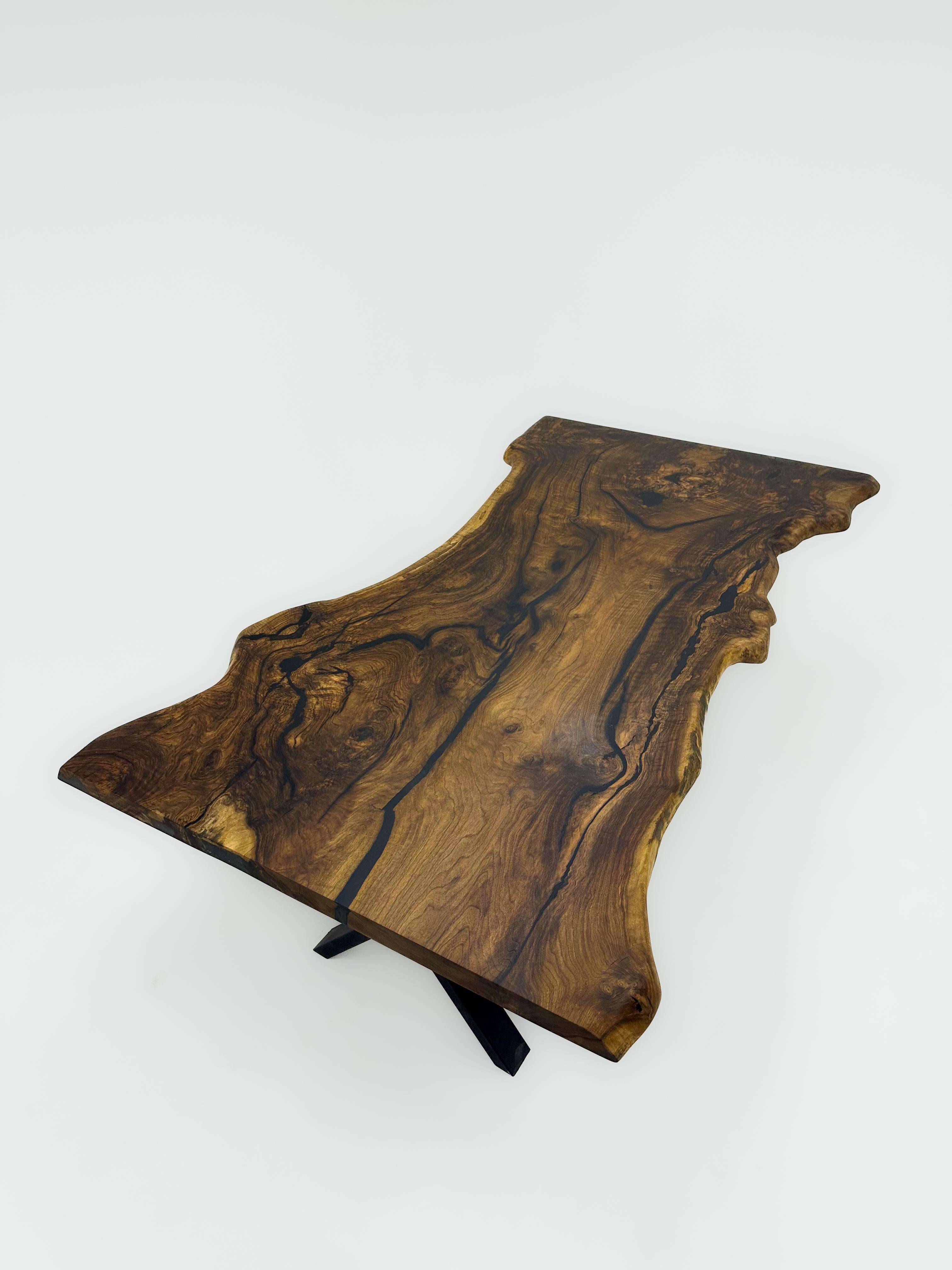 LIVE EDGE WALNUT CONFERENCE TABLE

This table is made of natural walnut slabs. 

Some Walnut slabs have a lot of natural beauty as it’s one side has a large curve. This is one of them! 

We've filled the cracks with black epoxy, without disrupting