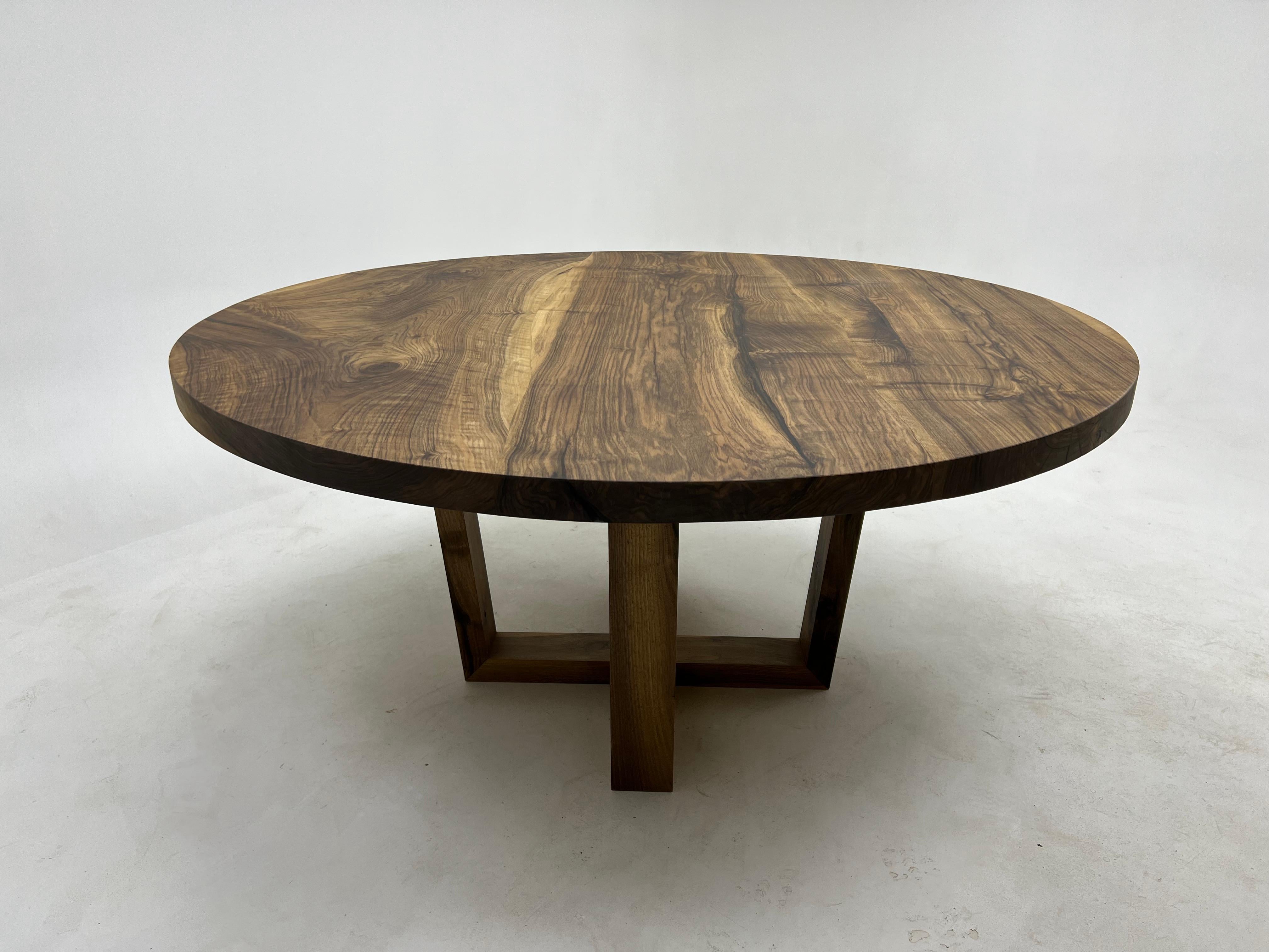 This wooden round table is made from high-quality Turkish walnut wood, known for its warm color and beautiful textures.

 You can use it as a dining table, a focal point in your living area, or a  conference room table.

The smooth, polished surface