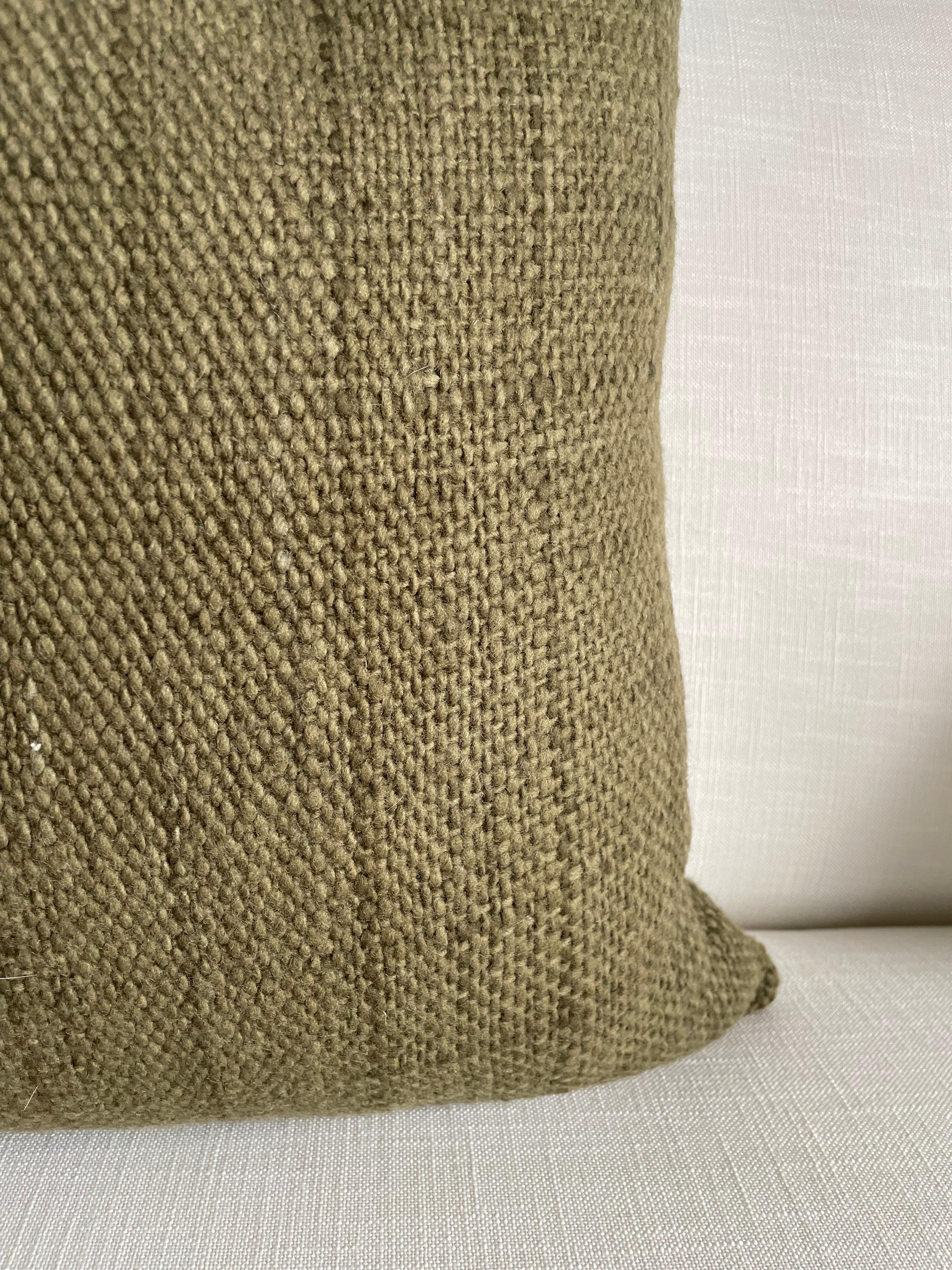 A beautiful moss green woven wool pillow that is soft to the touch.
Zipper Closure. 
Hand spun and woven by female artisans in Chile on traditional back-strap looms, these cushions make a beautiful statement accent for the living room or bed.