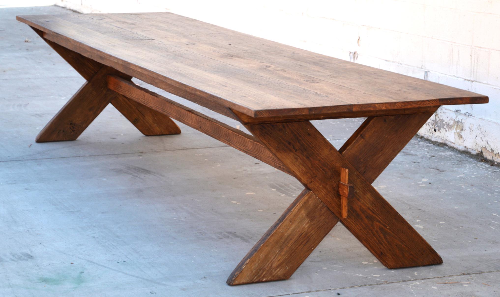 This X-base trestle table is made by hand, in our own workshop, from hand-selected antique, reclaimed heart pine. It is fully collapsible and assembles in 2 minutes without the need for tools, enabling it to be shipped flat. This price applies to