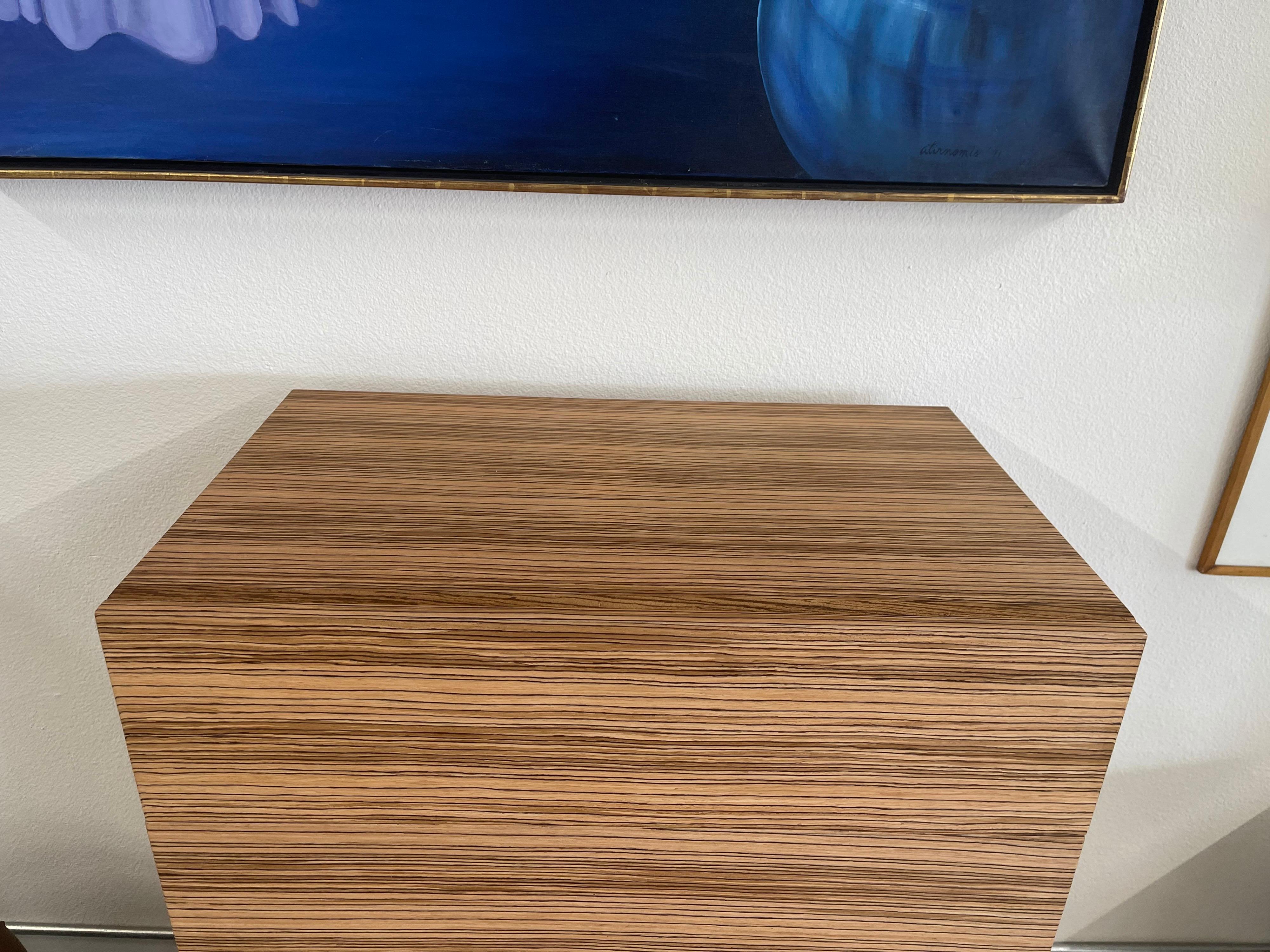 Pretty Zebrawood wood chest in a hard to find tall size. We had this custom made with solid brass spun legs. The chest has zebrawood veneer with solid zebra edges and solid oak drawers. No pulls on the front as we like the clean look. Drawers open