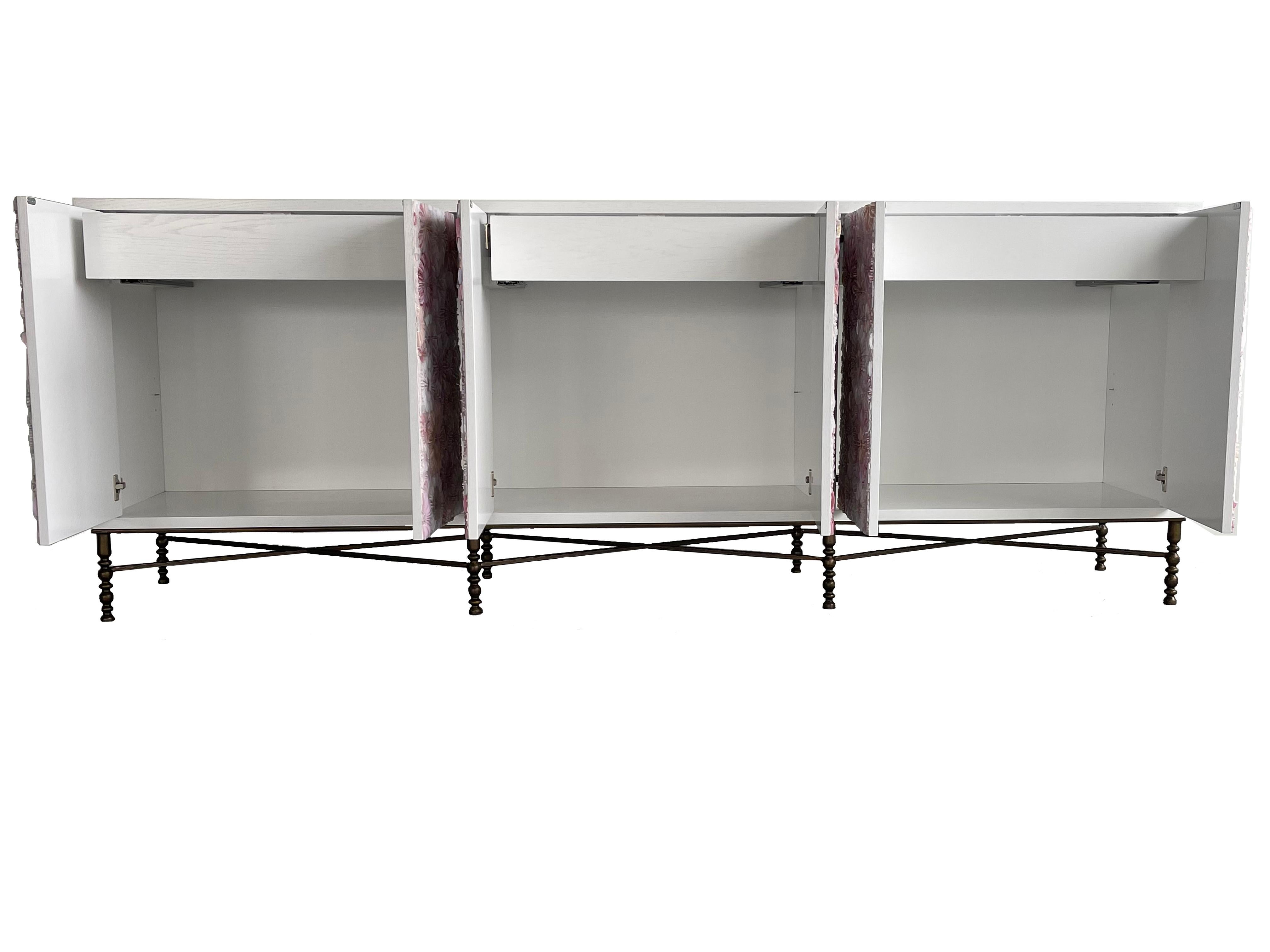 The blossom buffet by Ercole Home has a 6-door touch latch front, with painted white on oak wood finish.
This buffet contains three compartments each with one adjustable shelf and a drawer with built in self closing systems.
Hand cut glass mosaic